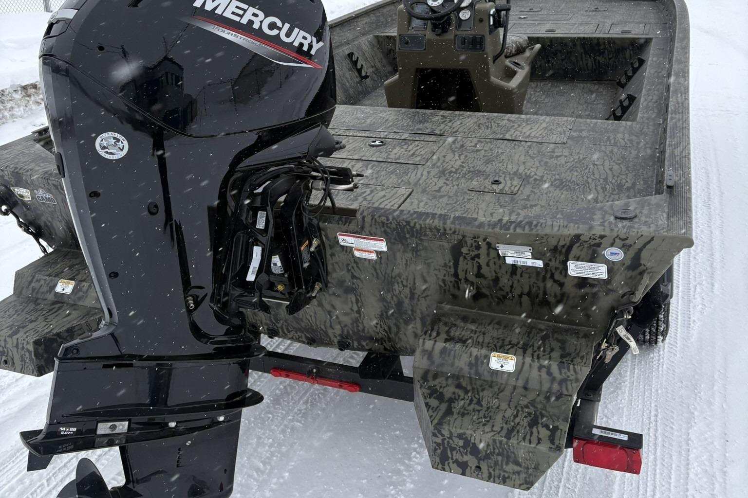2025 Tracker Grizzly 2072 CC boat with Mercury engine in snowy setting.