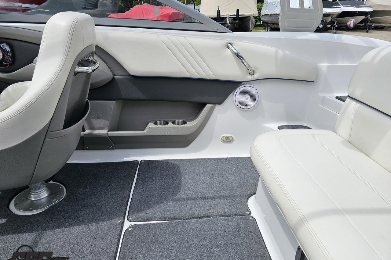 Interior of a 2010 Cobalt 232 WSS boat with white seating and carpeted flooring.