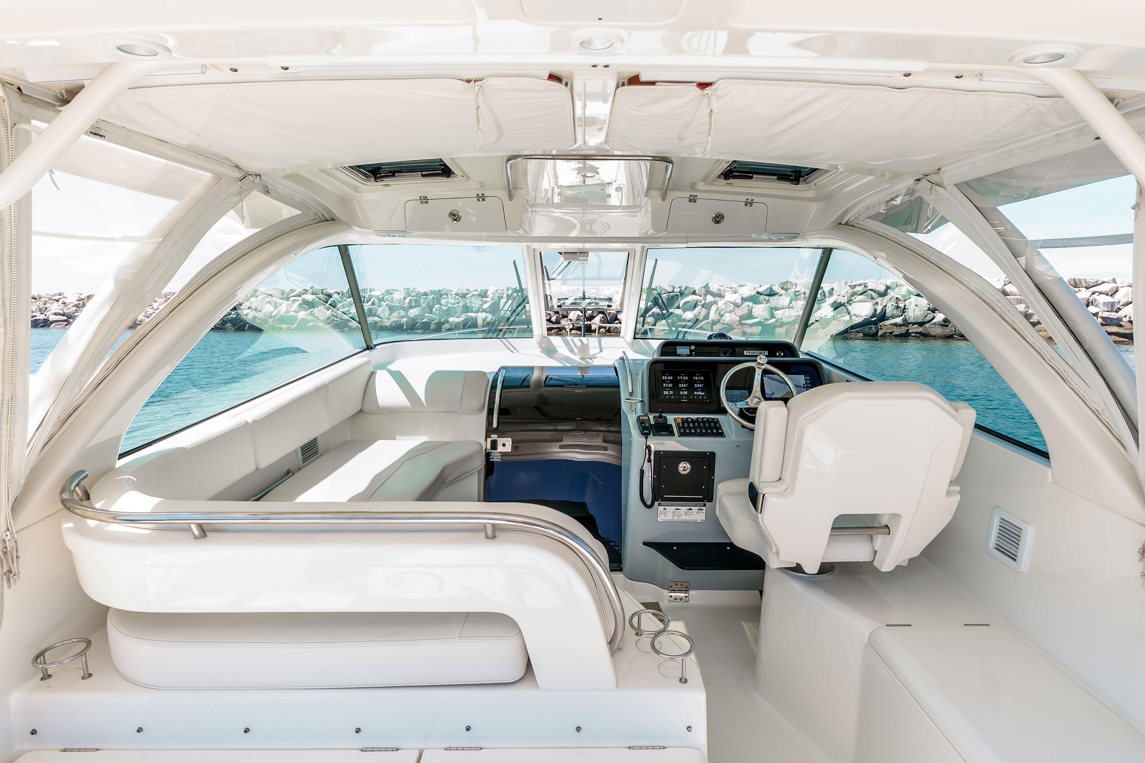 Interior of 2022 Pursuit OS 385 Offshore boat, featuring sleek design and modern controls.