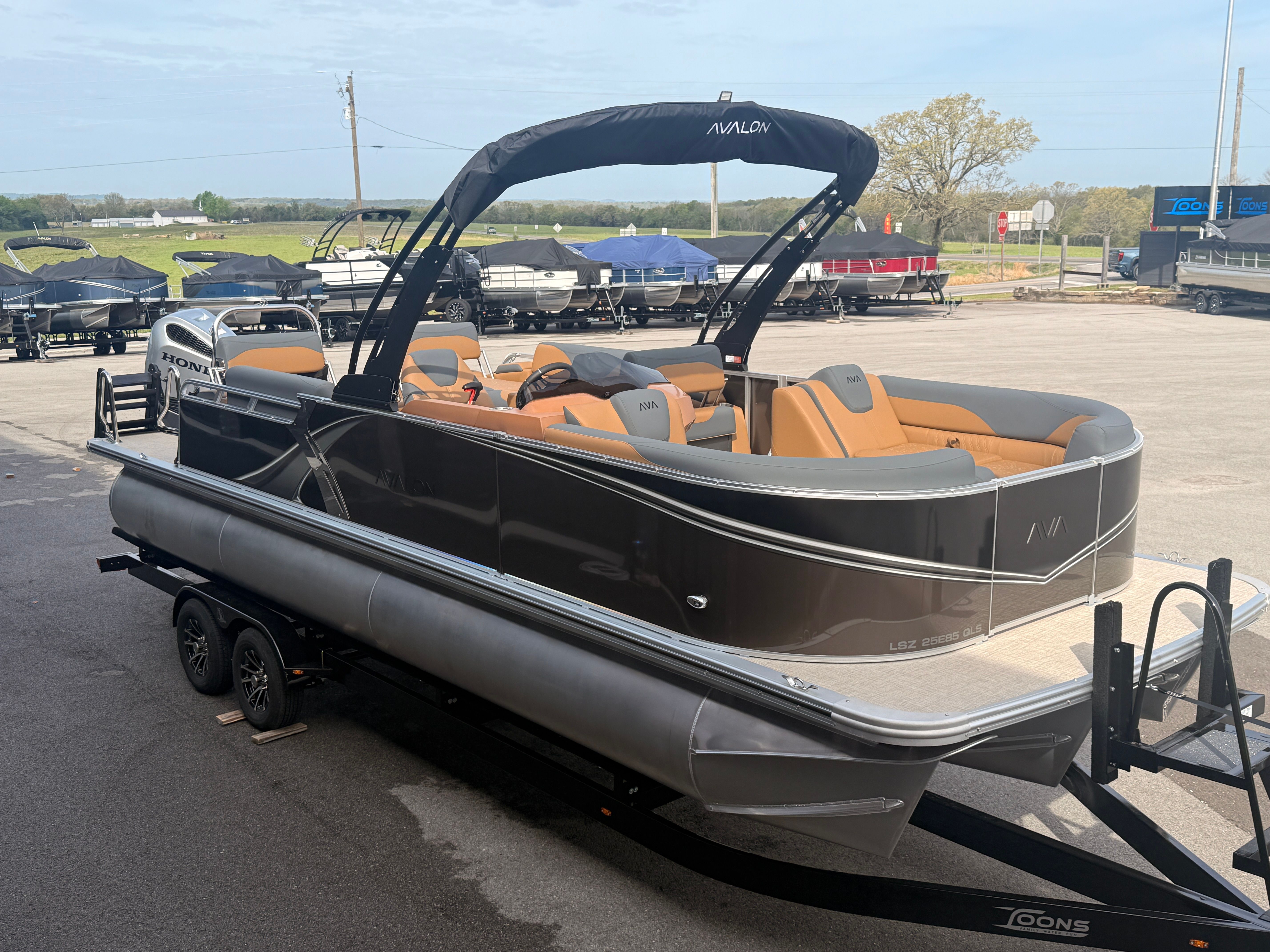 2026 Avalon 2385 LSZ pontoon boat on trailer outdoors.