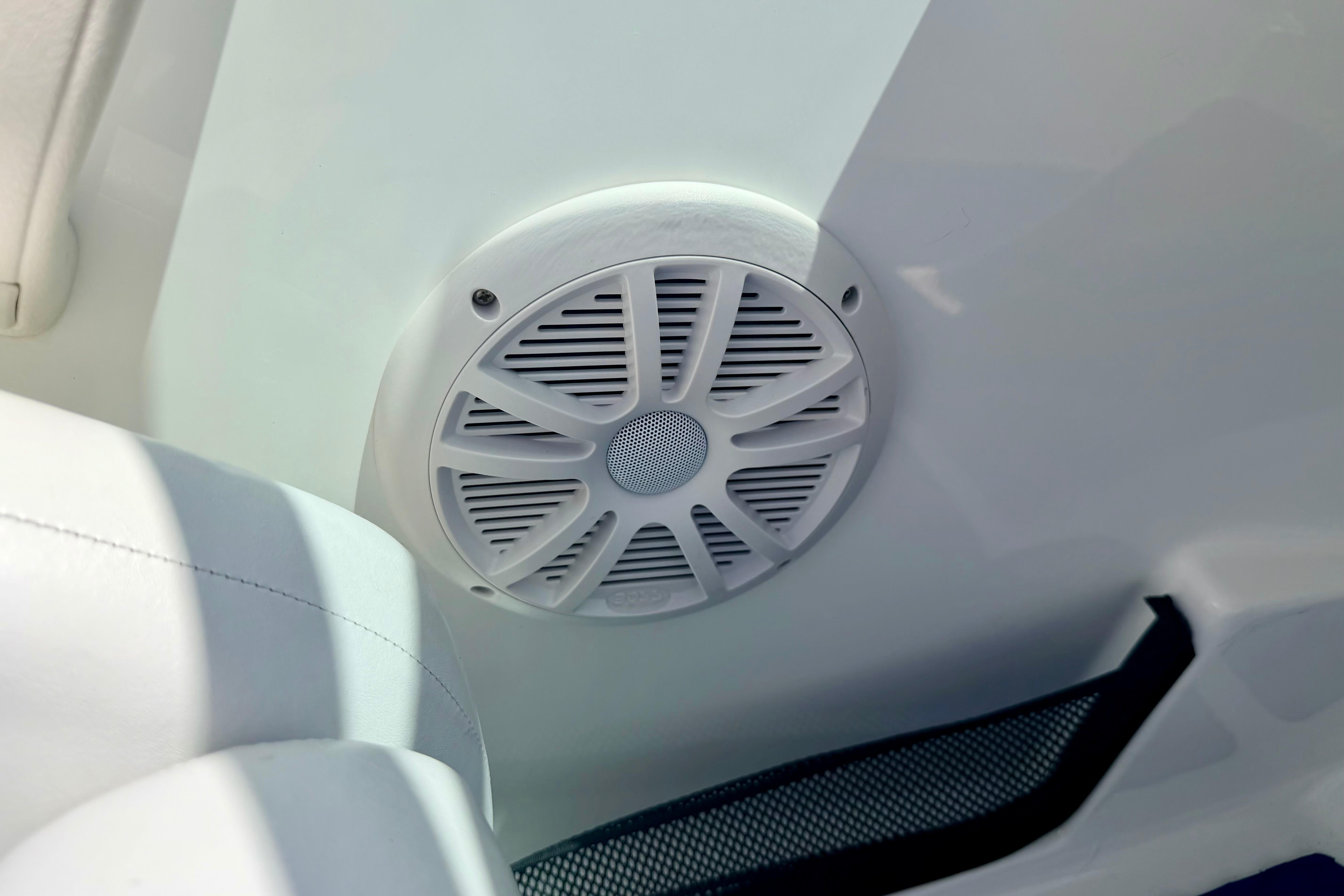 Speaker on 2004 Bombardier SEADOO Utopia 185 boat interior, white upholstery.