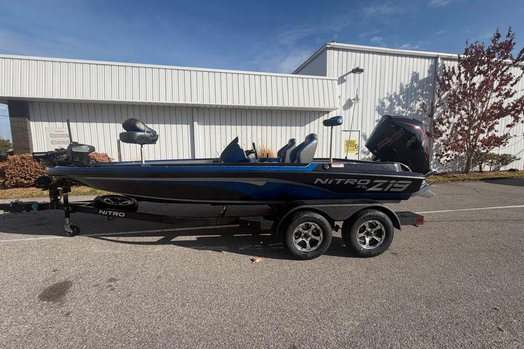2026 Nitro Z19 XL Pro boat parked outdoors, showcasing sleek design and dual-axle trailer.