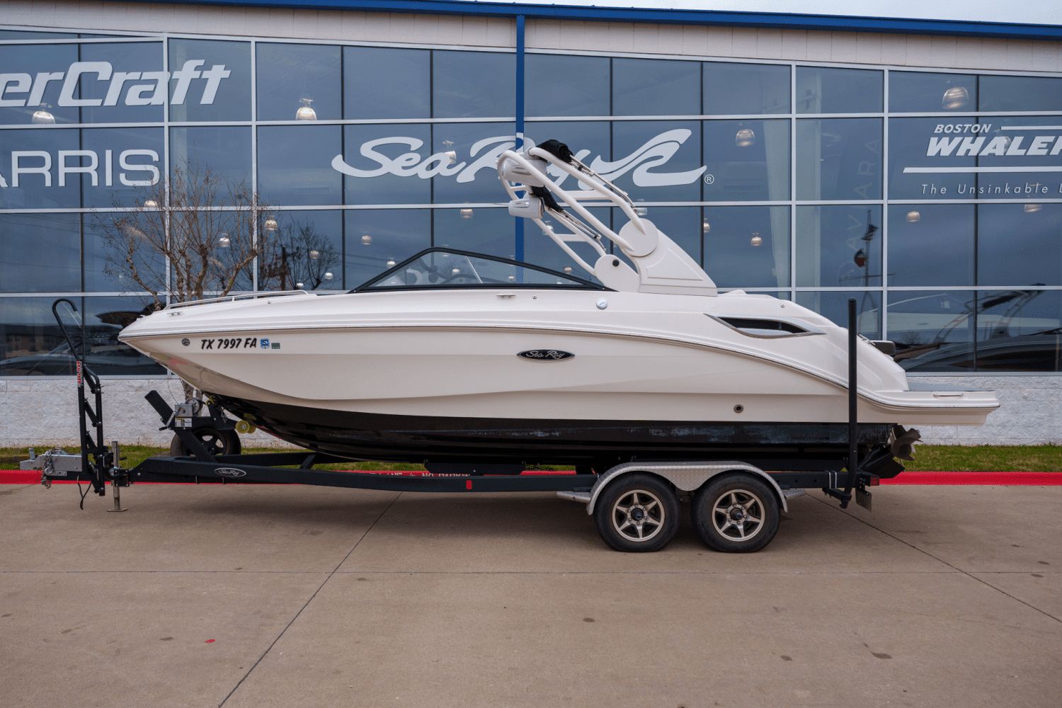 2019 Sea Ray SDX 250 boat on trailer in front of showroom.