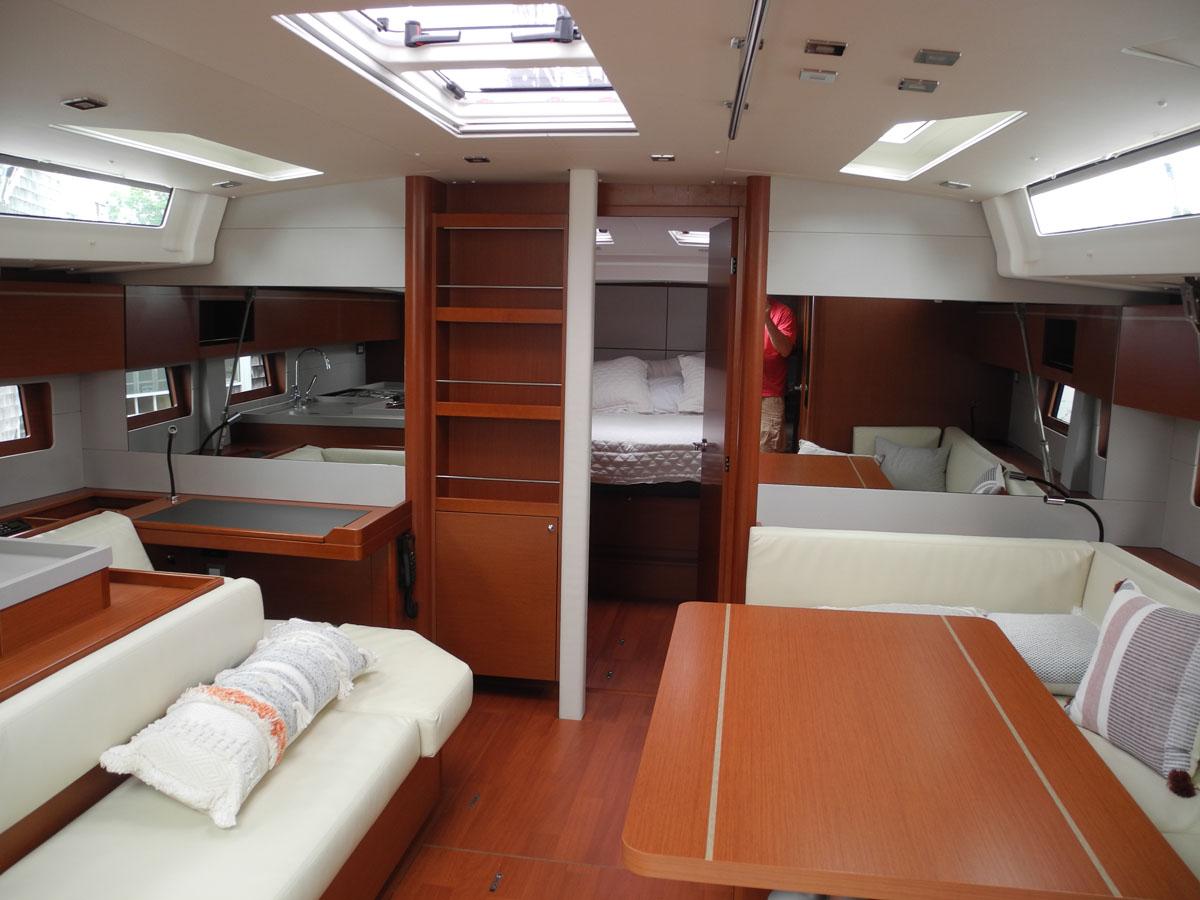 Luxurious interior of 2020 Beneteau Oceanis 51.1 yacht with modern wood finish and spacious layout.