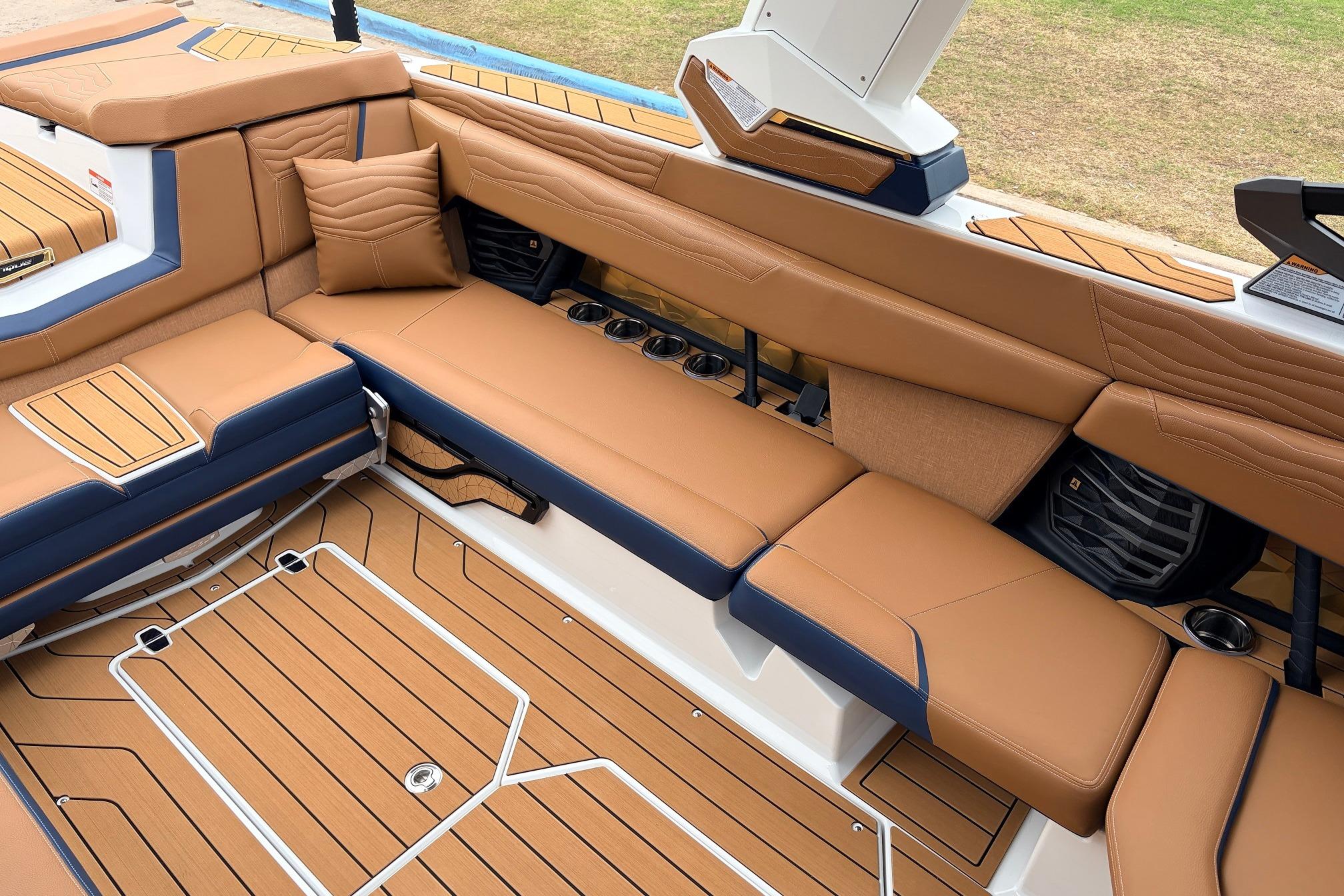 Luxurious interior of 2026 Nautique Super Air Nautique G25 boat with tan seating.