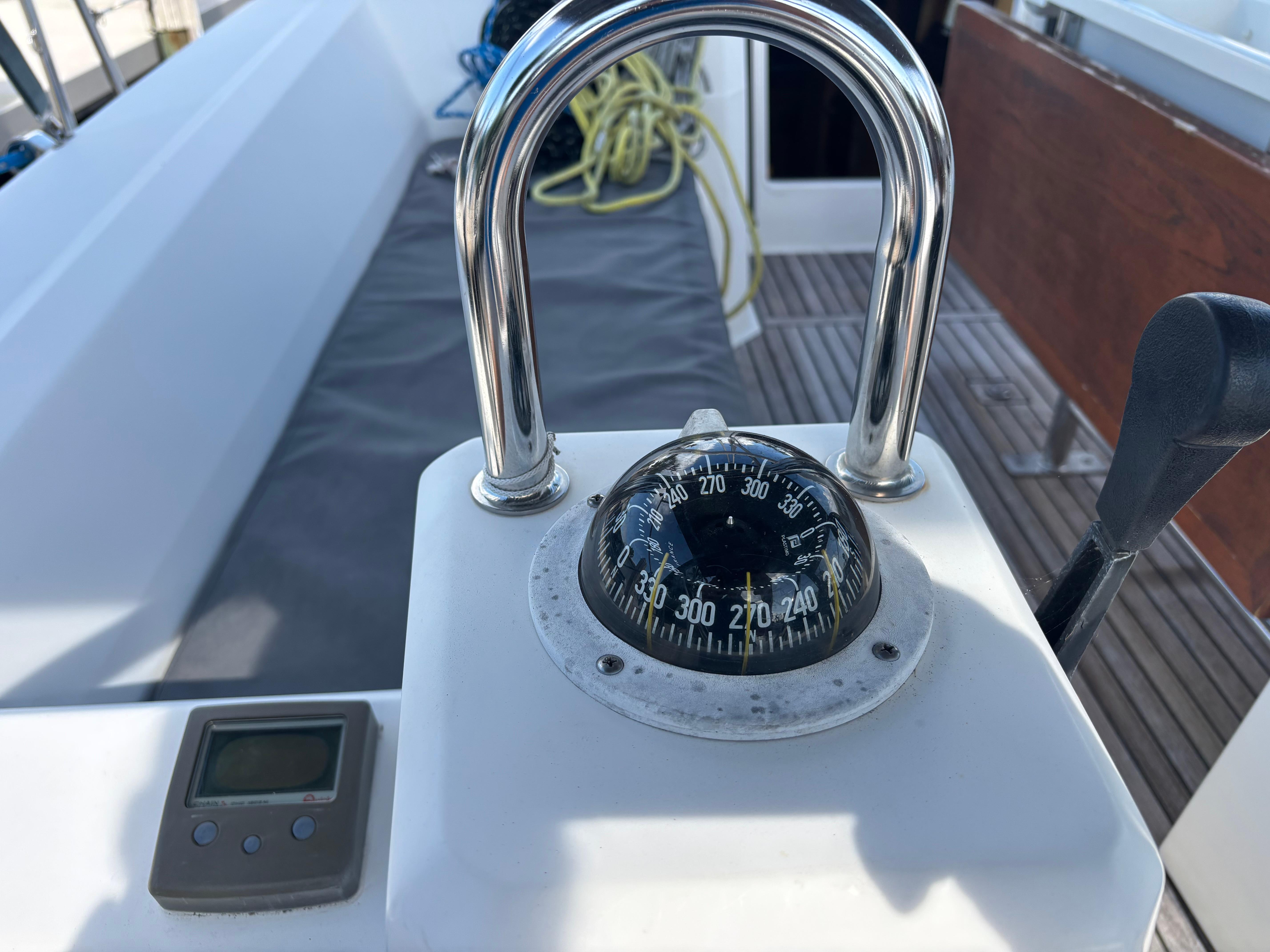 Compass and controls on a 2015 Beneteau Oceanis 35 sailboat deck.