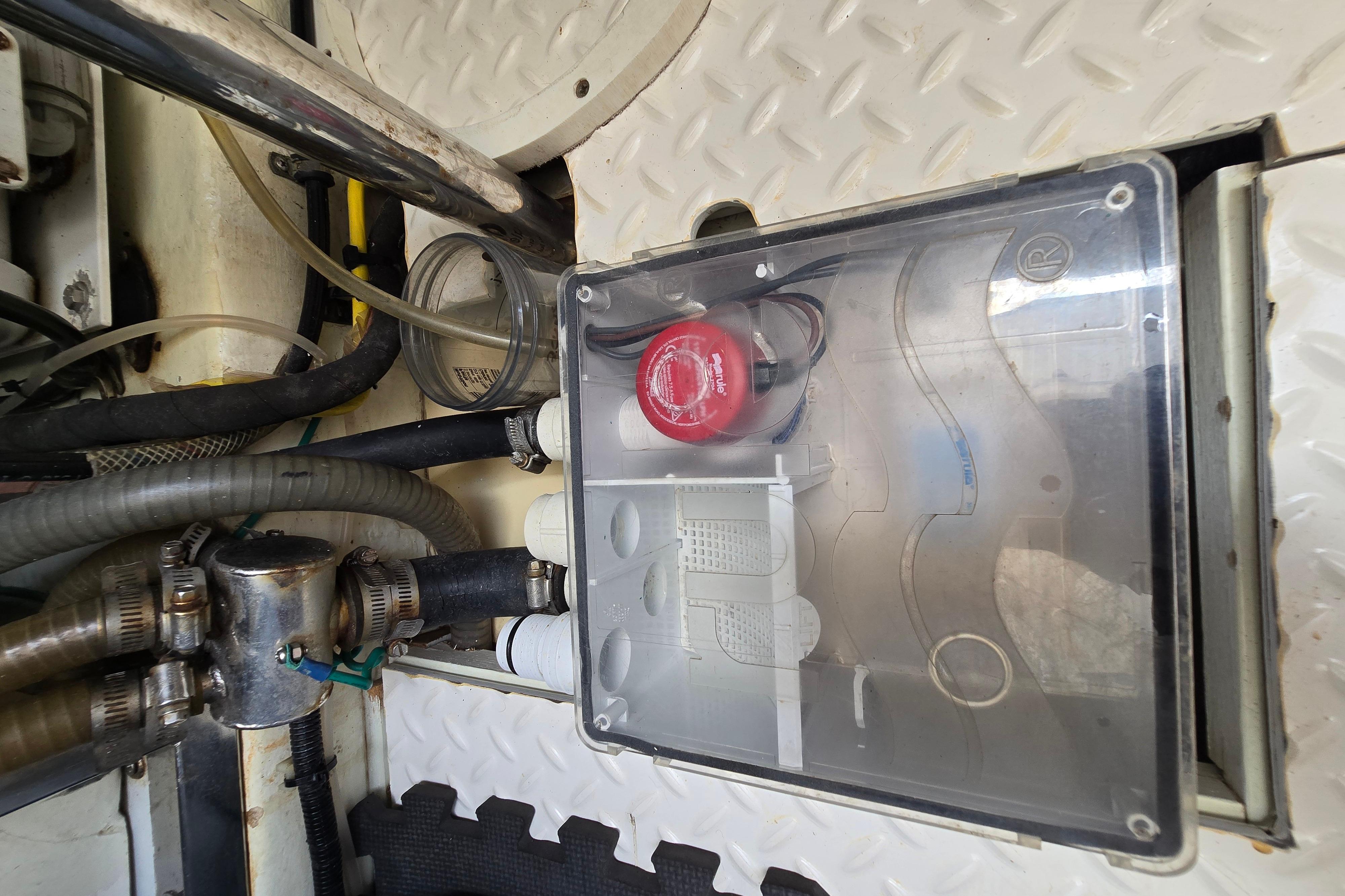 Engine room of 2004 Grand Harbour 58 yacht, featuring mechanical components and wiring.