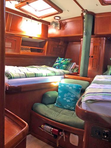 Interior of a 1988 Little Harbor 53 with cozy beds and wooden furnishings.