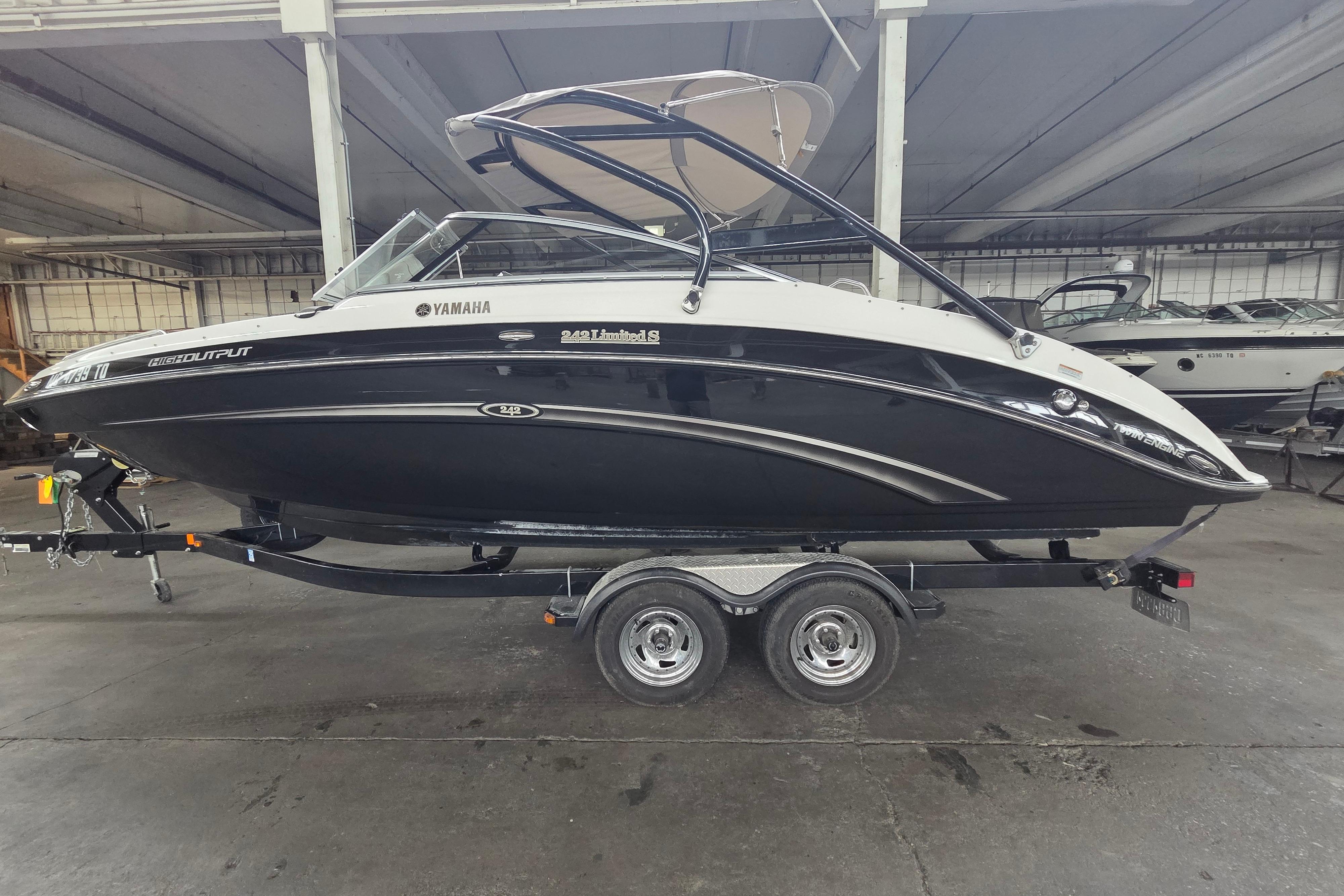 2013 Yamaha 242 Limited S boat on trailer in indoor storage facility.