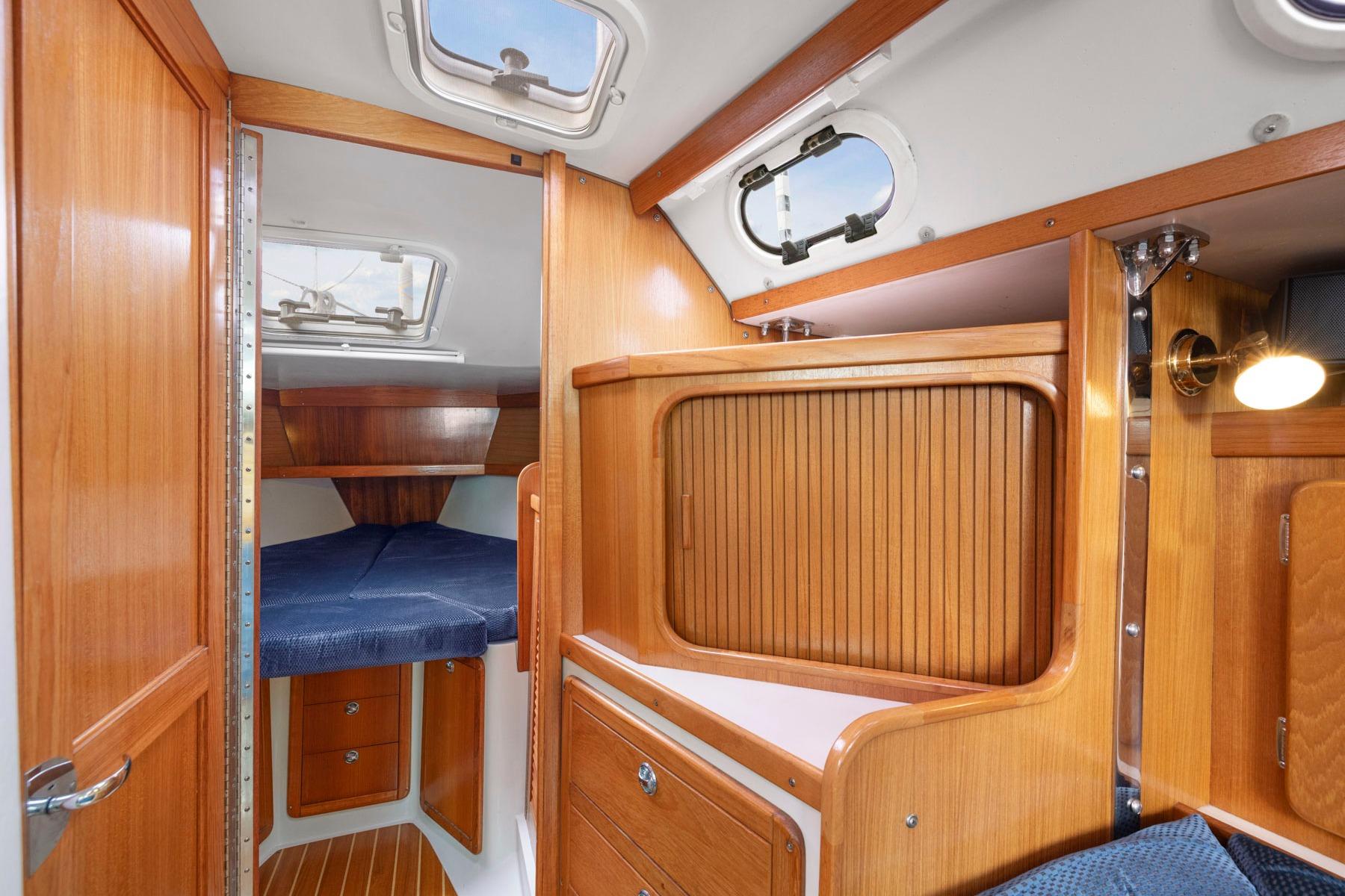 Interior of 2004 Catalina 36 MkII sailboat with wooden cabinetry and cozy sleeping area.