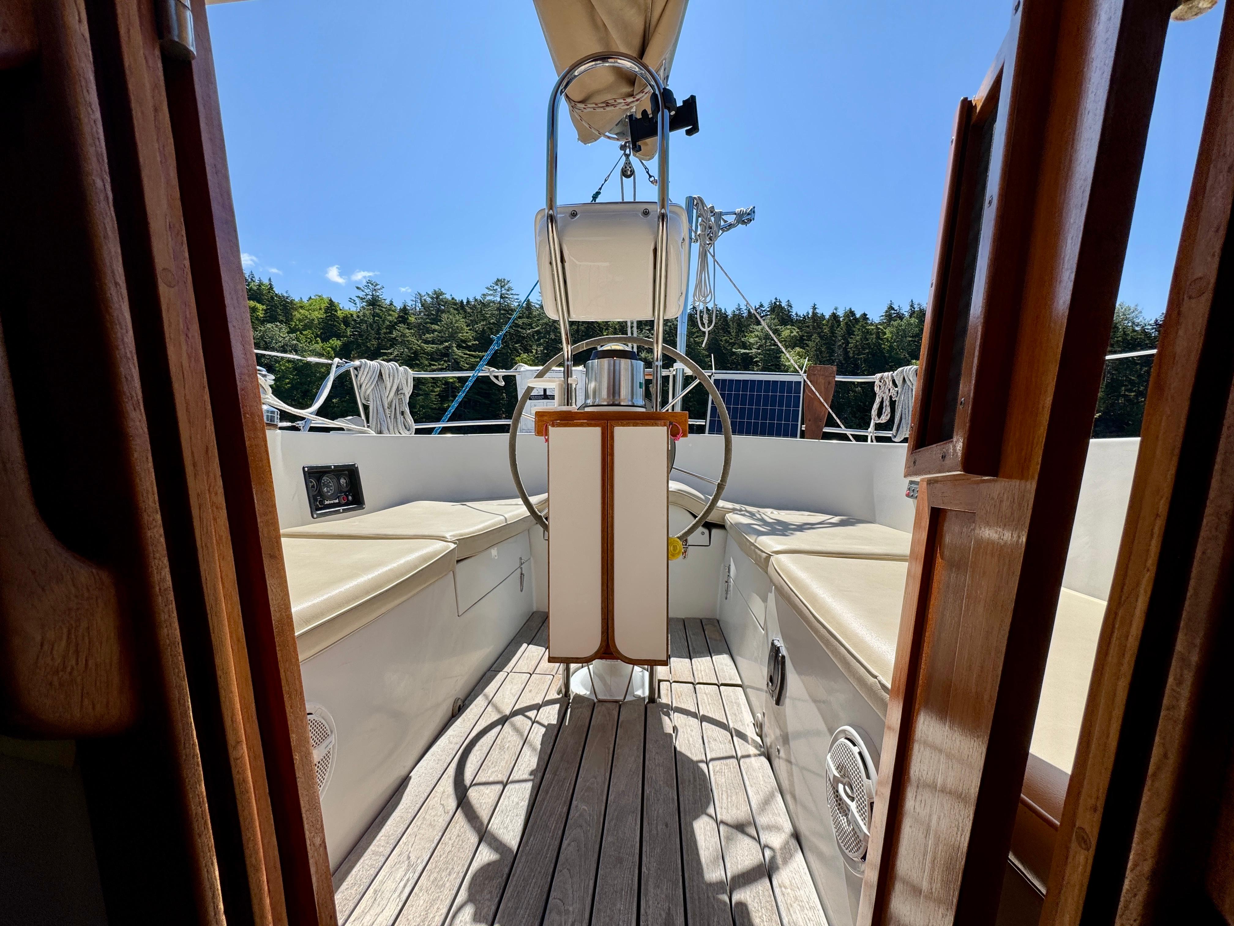 1989 Nonsuch 30 Ultra sailboat cockpit with wooden accents and steering wheel.