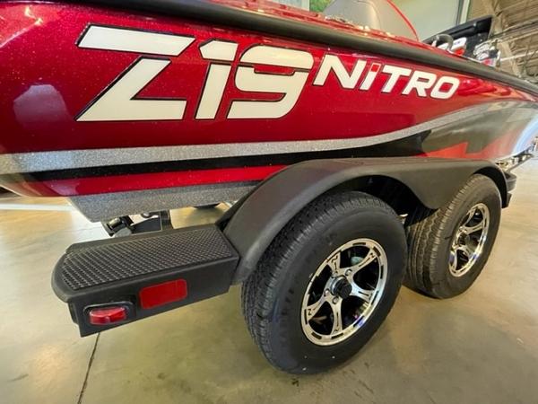 2025 Nitro Z19 boat with dual wheels and red exterior in a showroom.