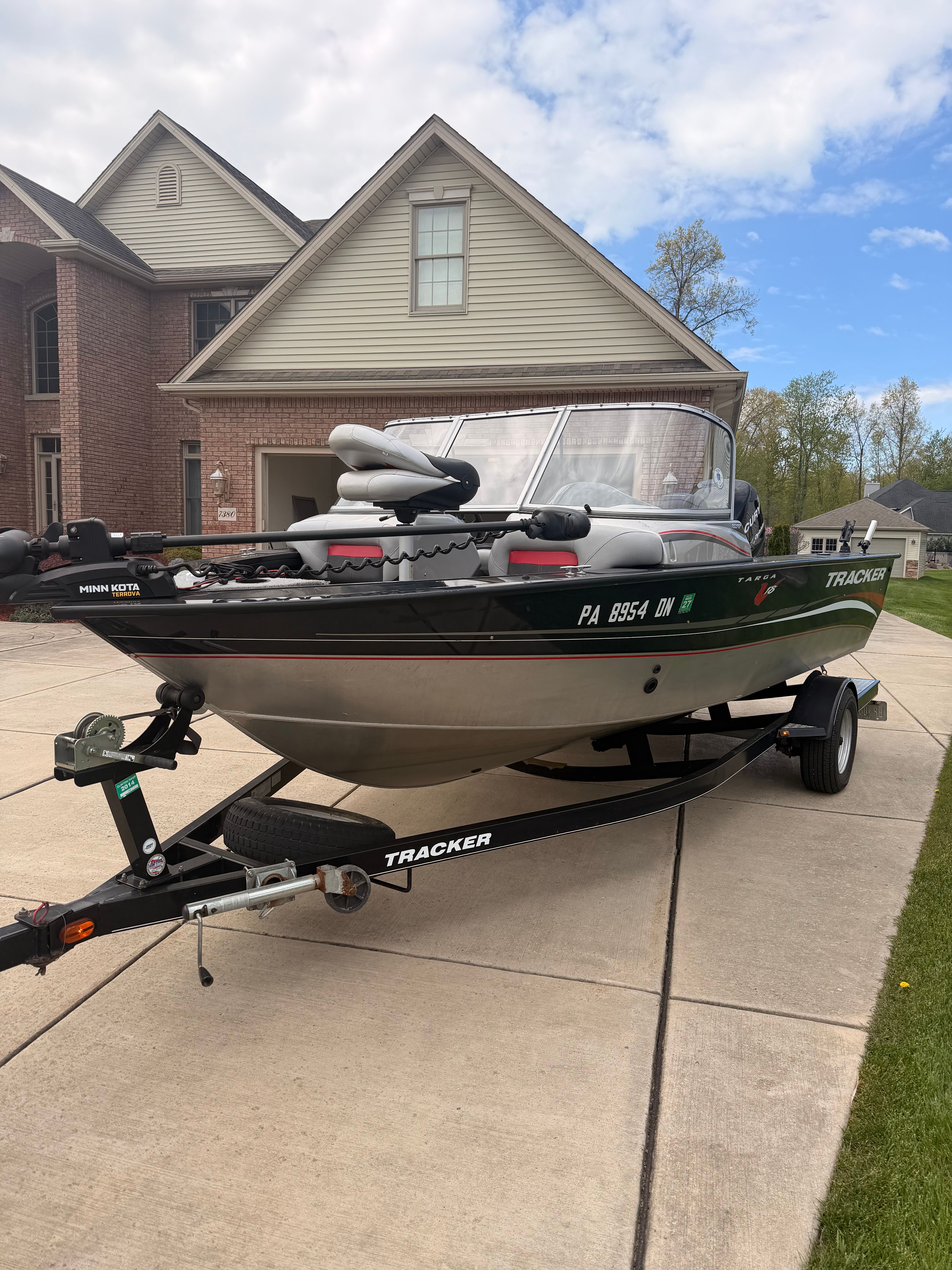 2013 Bass Tracker Targa V-18 WT on trailer in front of house.