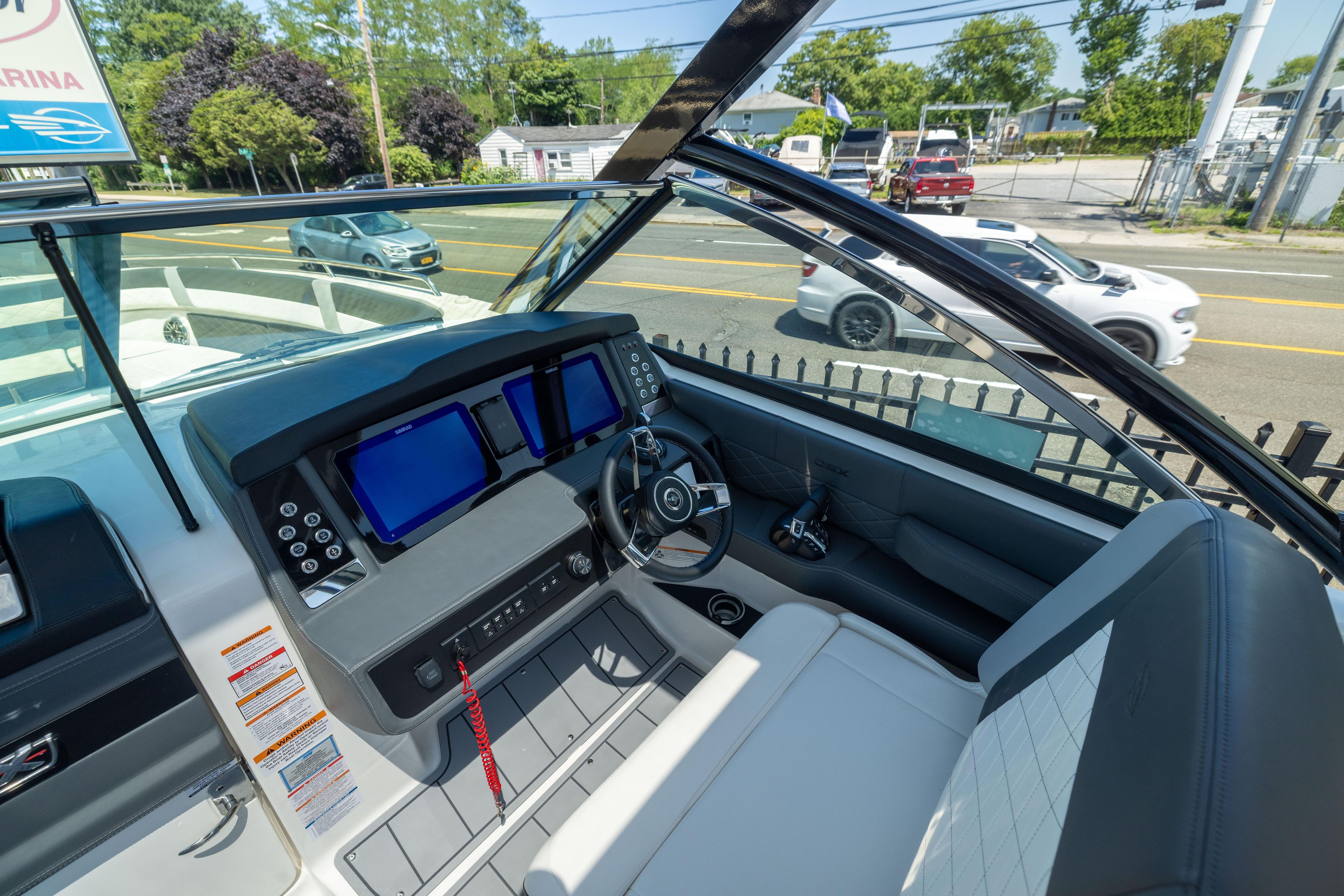 2026 Chaparral 310 OSX boat cockpit with modern dashboard and steering wheel.