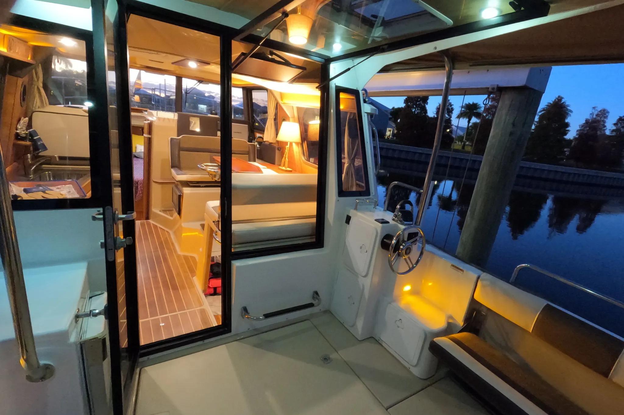 2015 Ranger Tugs R-29 S interior view with cozy seating and ambient lighting.