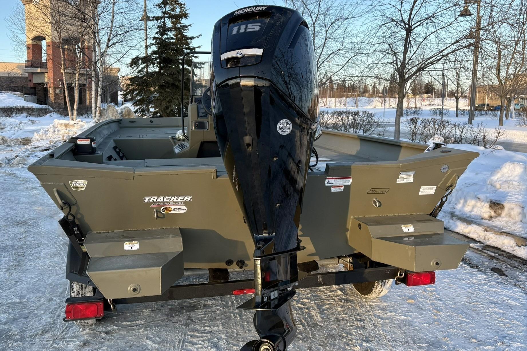 2024 Tracker Grizzly 2072 CC boat parked in snow.