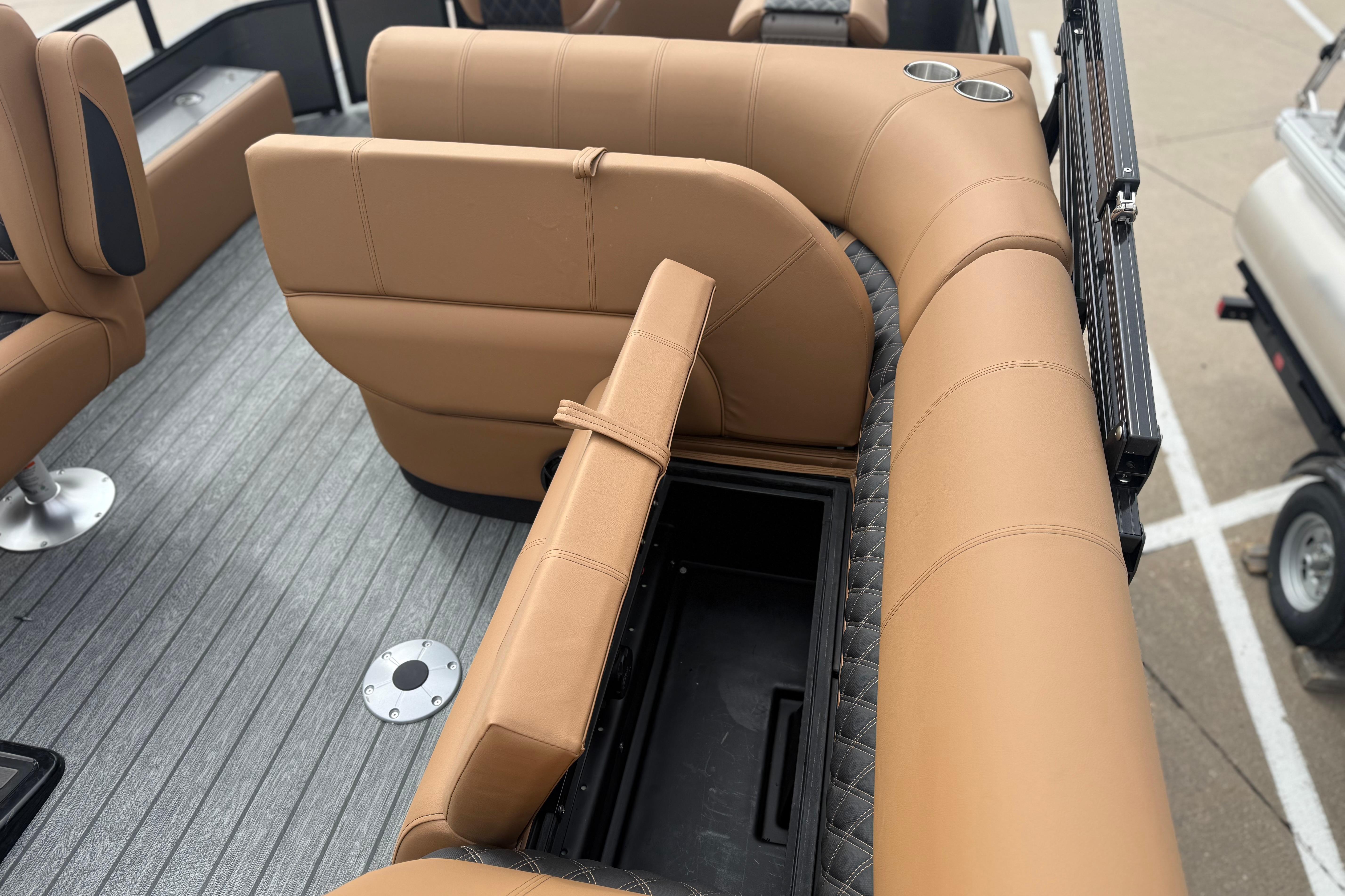 2026 Ranger 220F boat interior with tan leather seating and storage compartment.