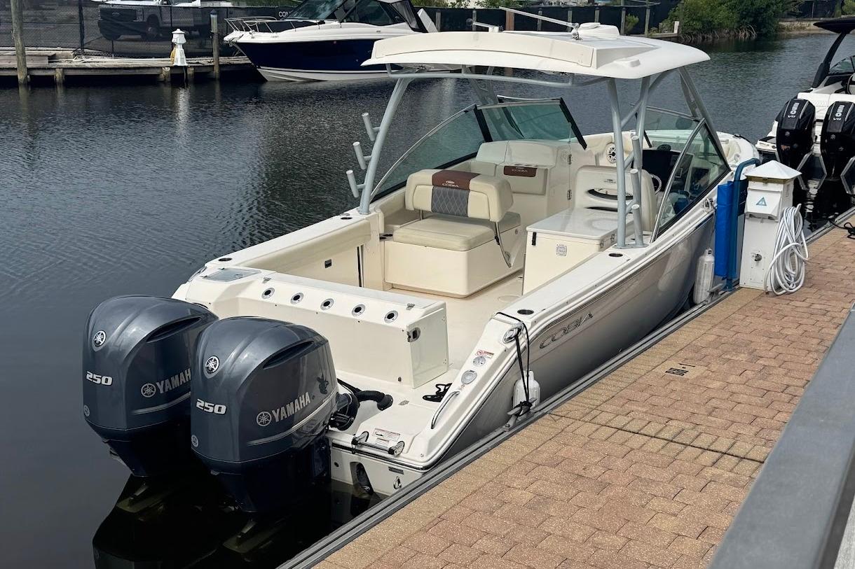 2020 Cobia 280 Dual Console boat docked with twin Yamaha 250 engines.