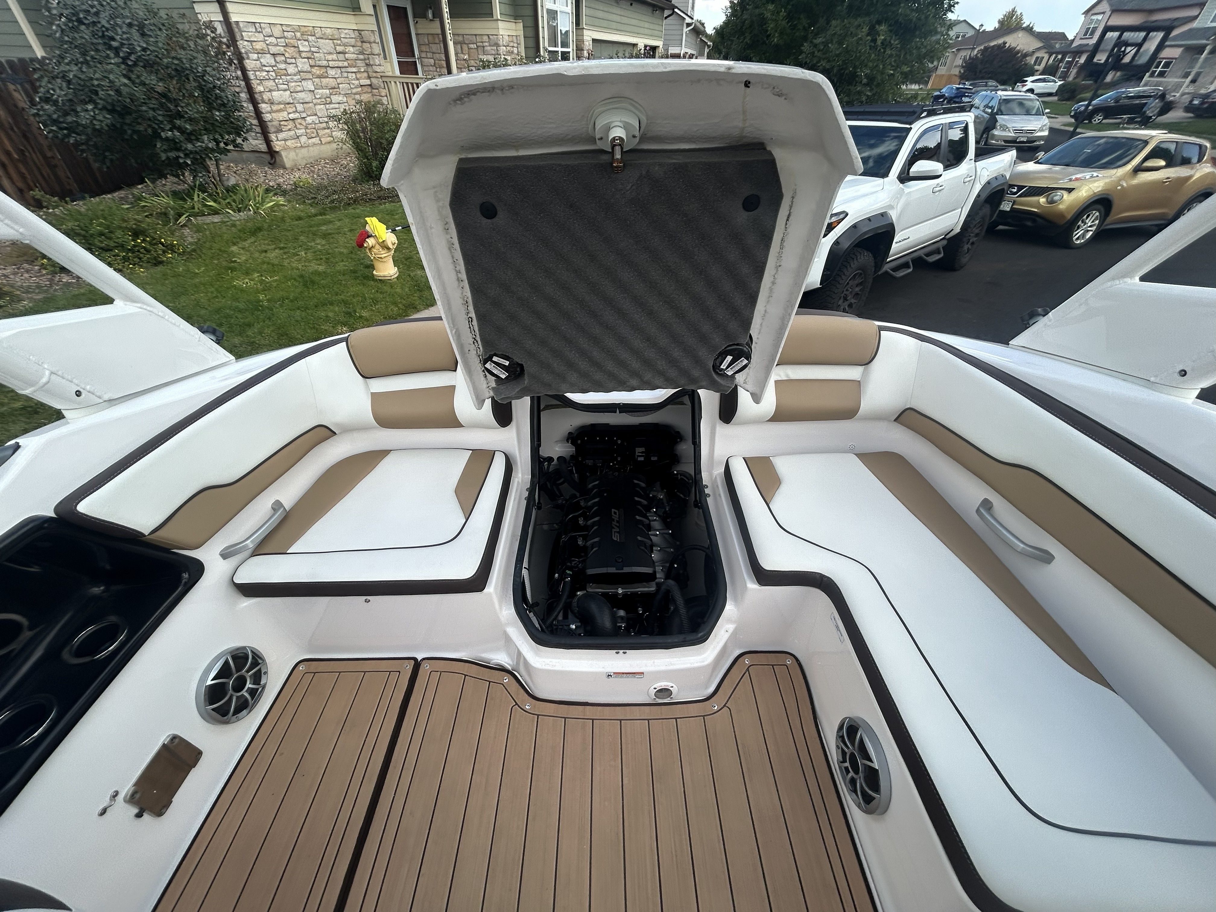 Interior of a 2022 Yamaha Boats 195S with open engine compartment.