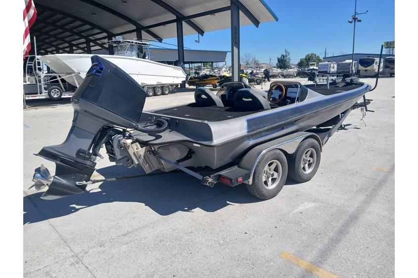 1994 Gambler 21 boat on trailer, parked outdoors under a canopy.