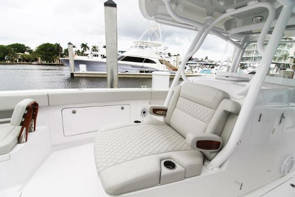 2024 Jupiter 34 HFS boat with luxurious seating at a marina.