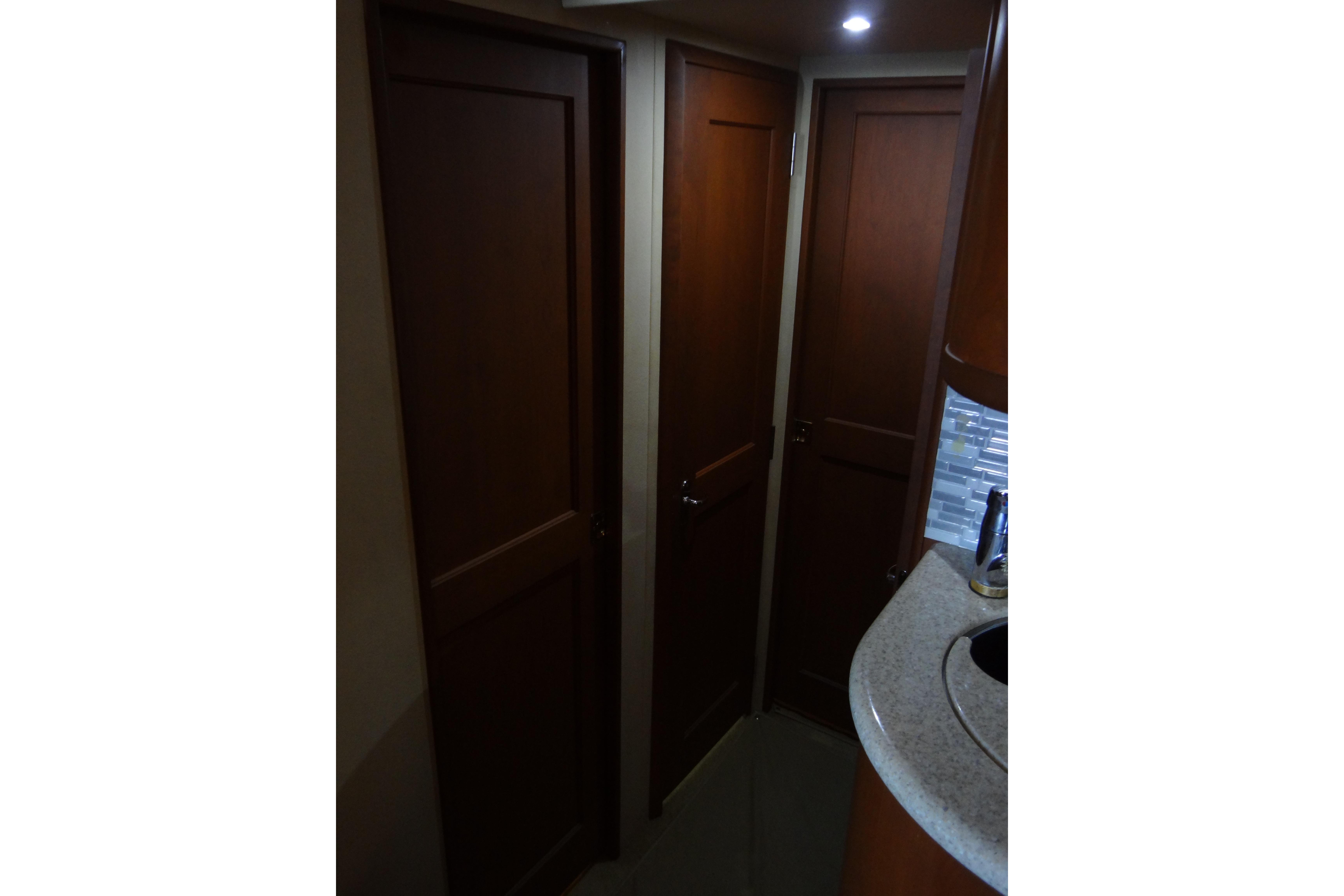 Interior view of 2005 Silverton 34 Convertible yacht with wooden doors and countertop.