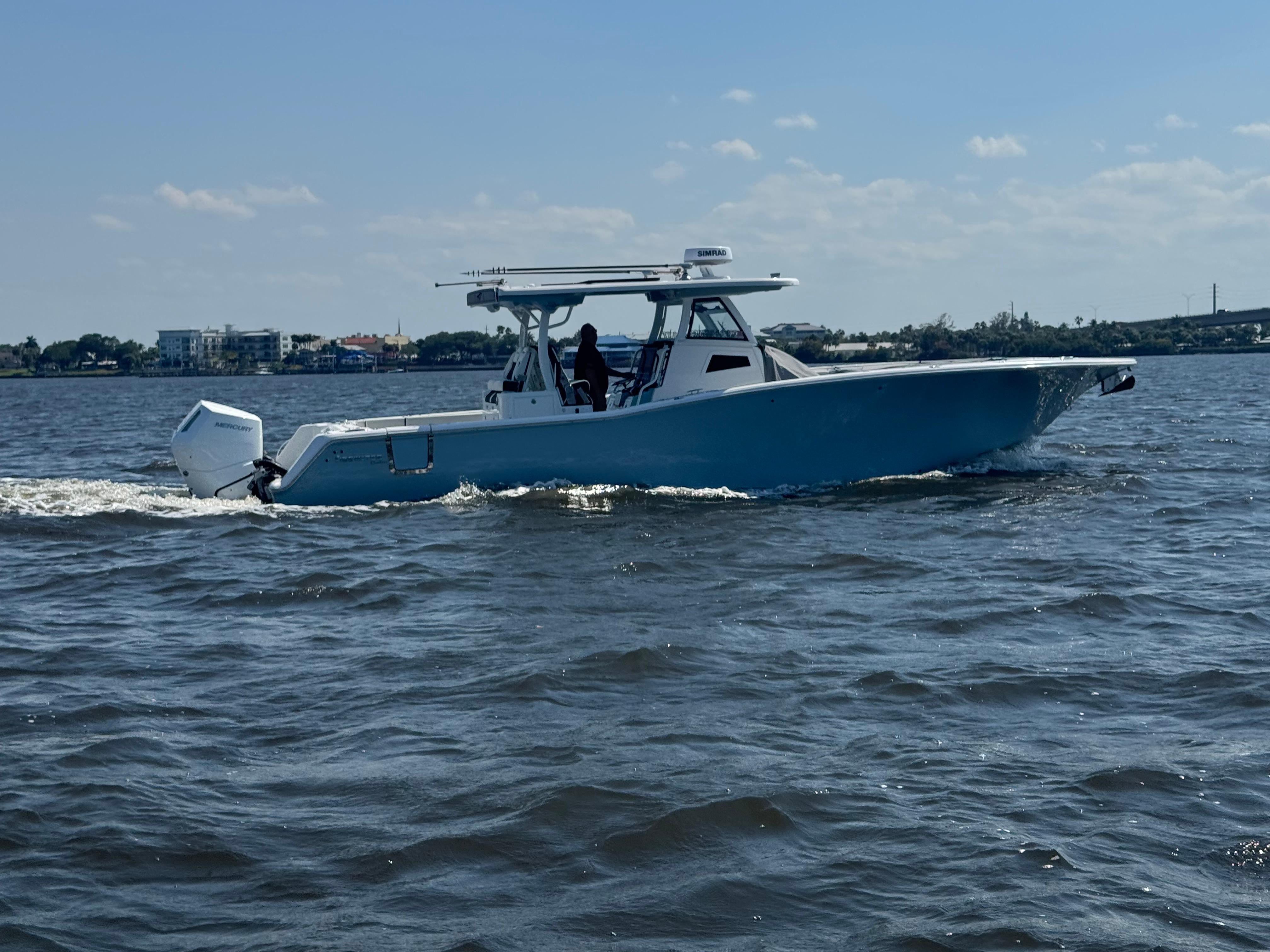 2024 Tidewater 380 CC Adventure boat cruising on open water.