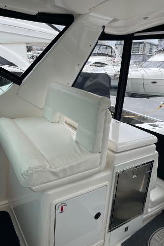 The image shows the cockpit of a 2003 Tiara Yachts 3500 Open with white upholstery.