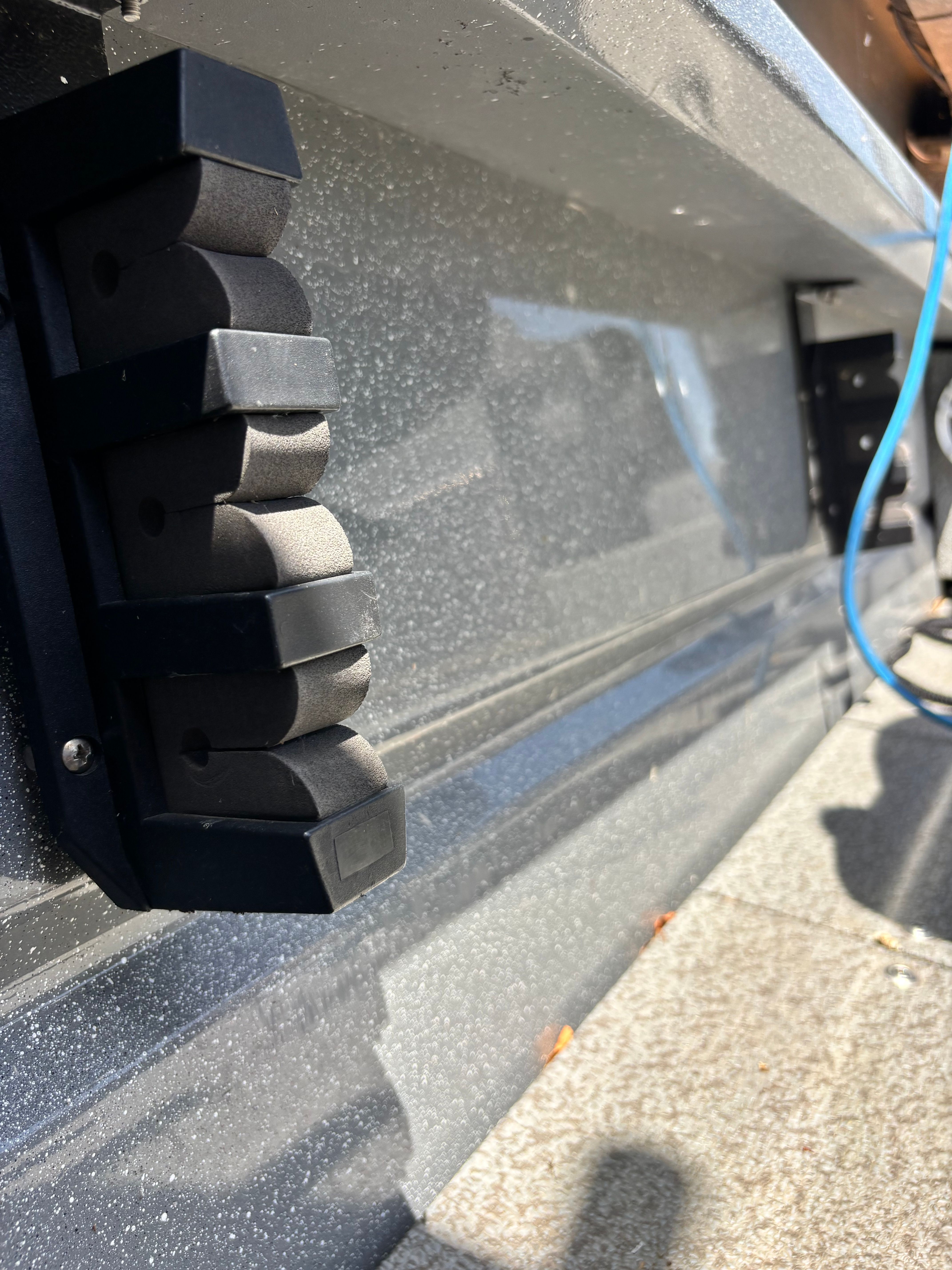 Close-up of a boat part with black accessories.