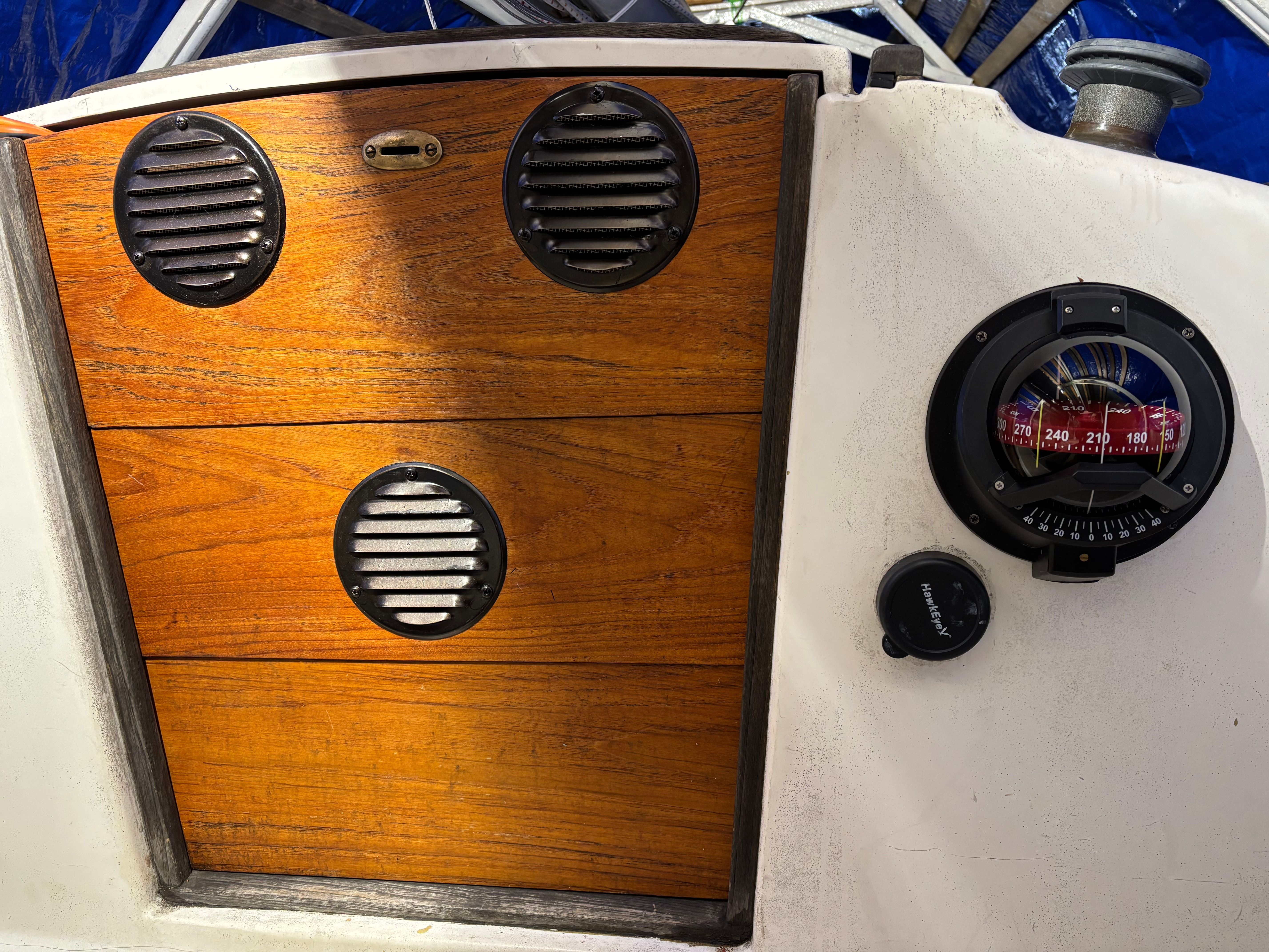 Wooden door with vents and compass on 1986 Cape Dory 26.