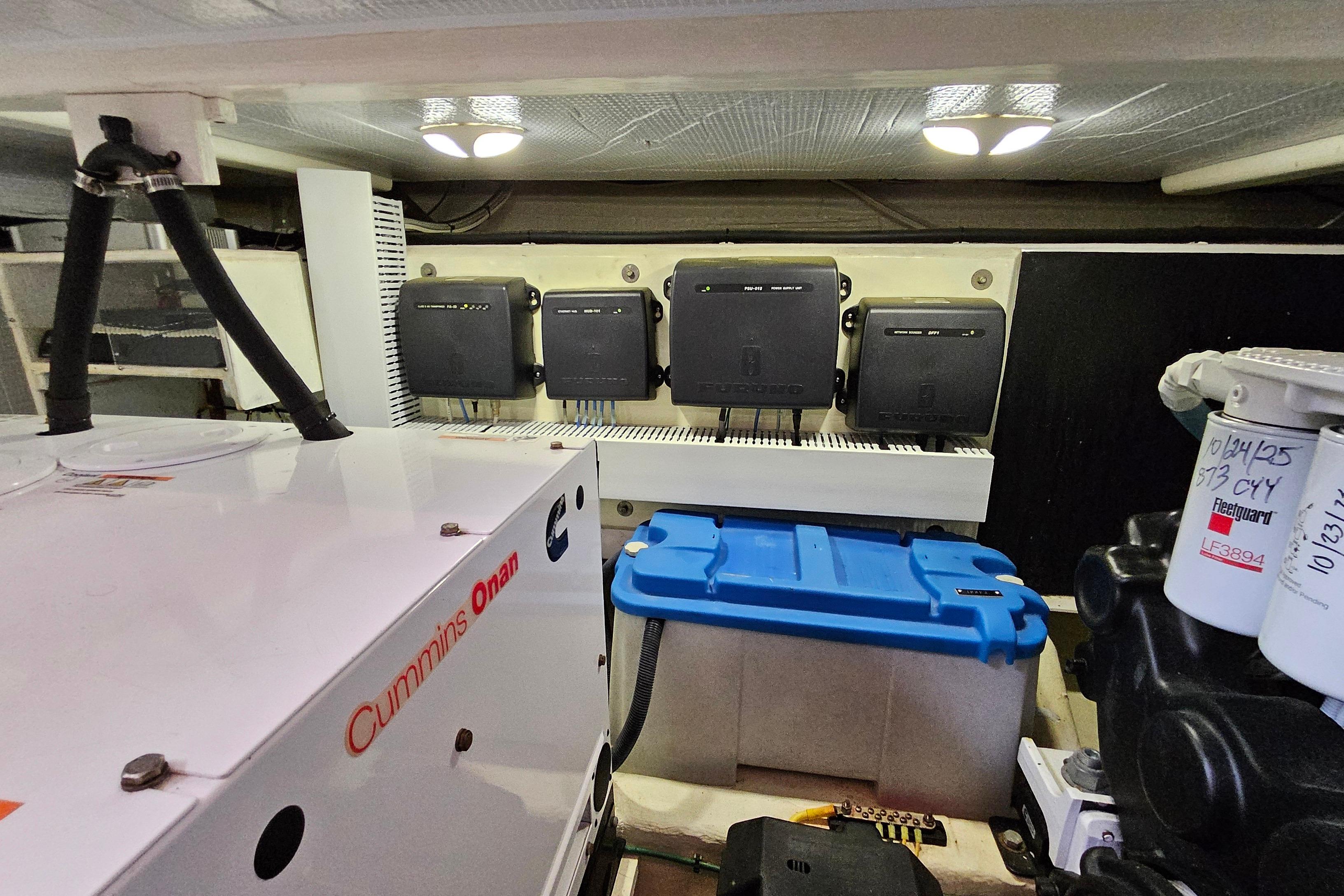 Engine room of 2015 Sabre 42 Salon Express with Cummins Onan generator and electrical components.