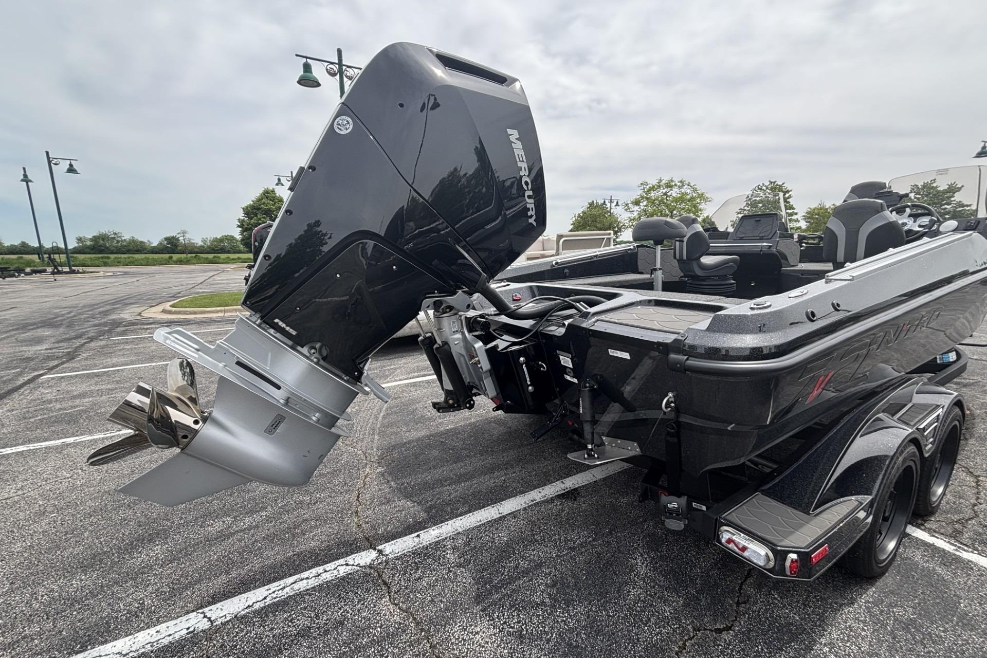 2026 Nitro ZV21 boat with Mercury outboard engine in parking lot.