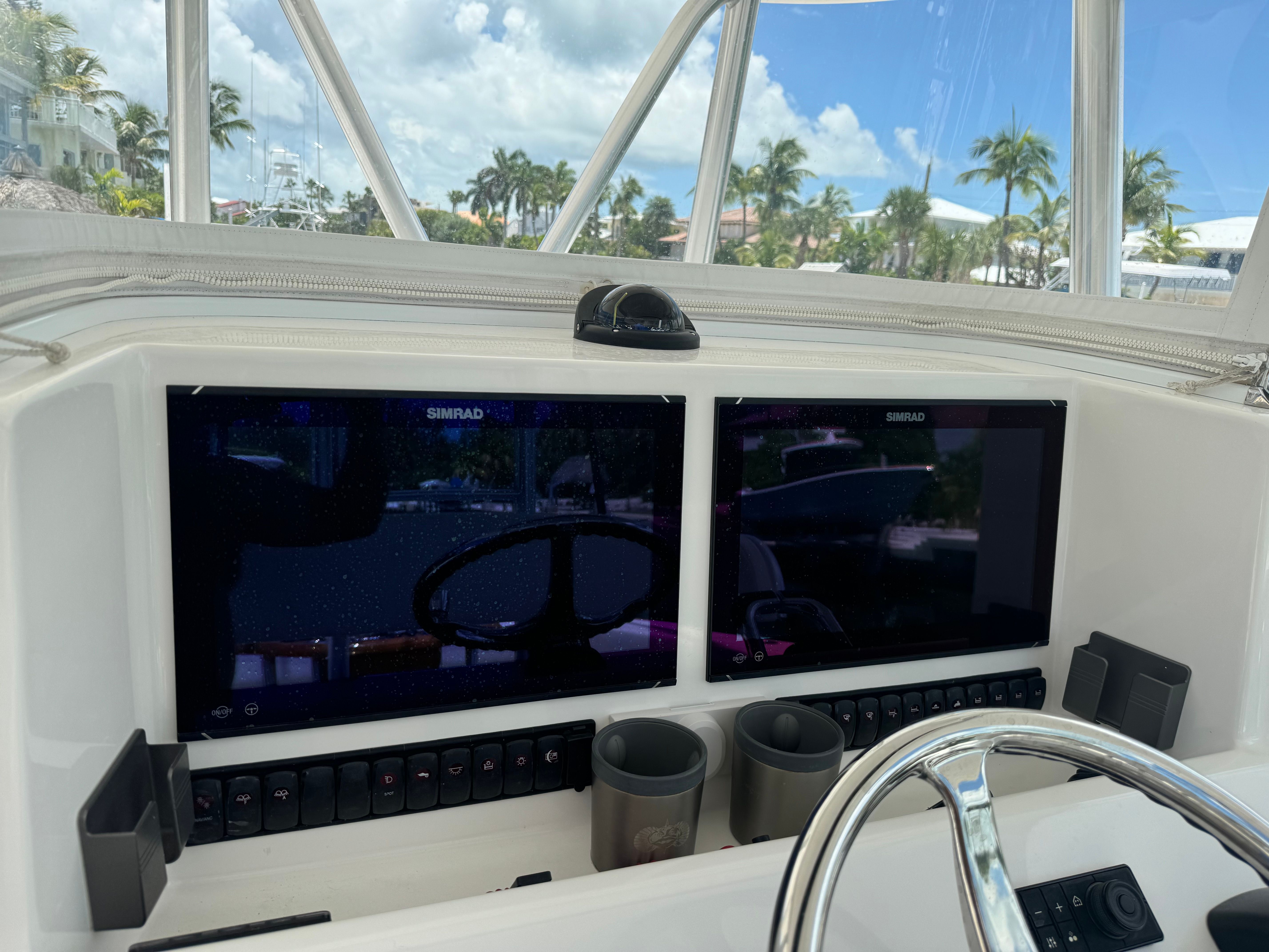 Venture CC 2019 boat console with Simrad screens and steering wheel.