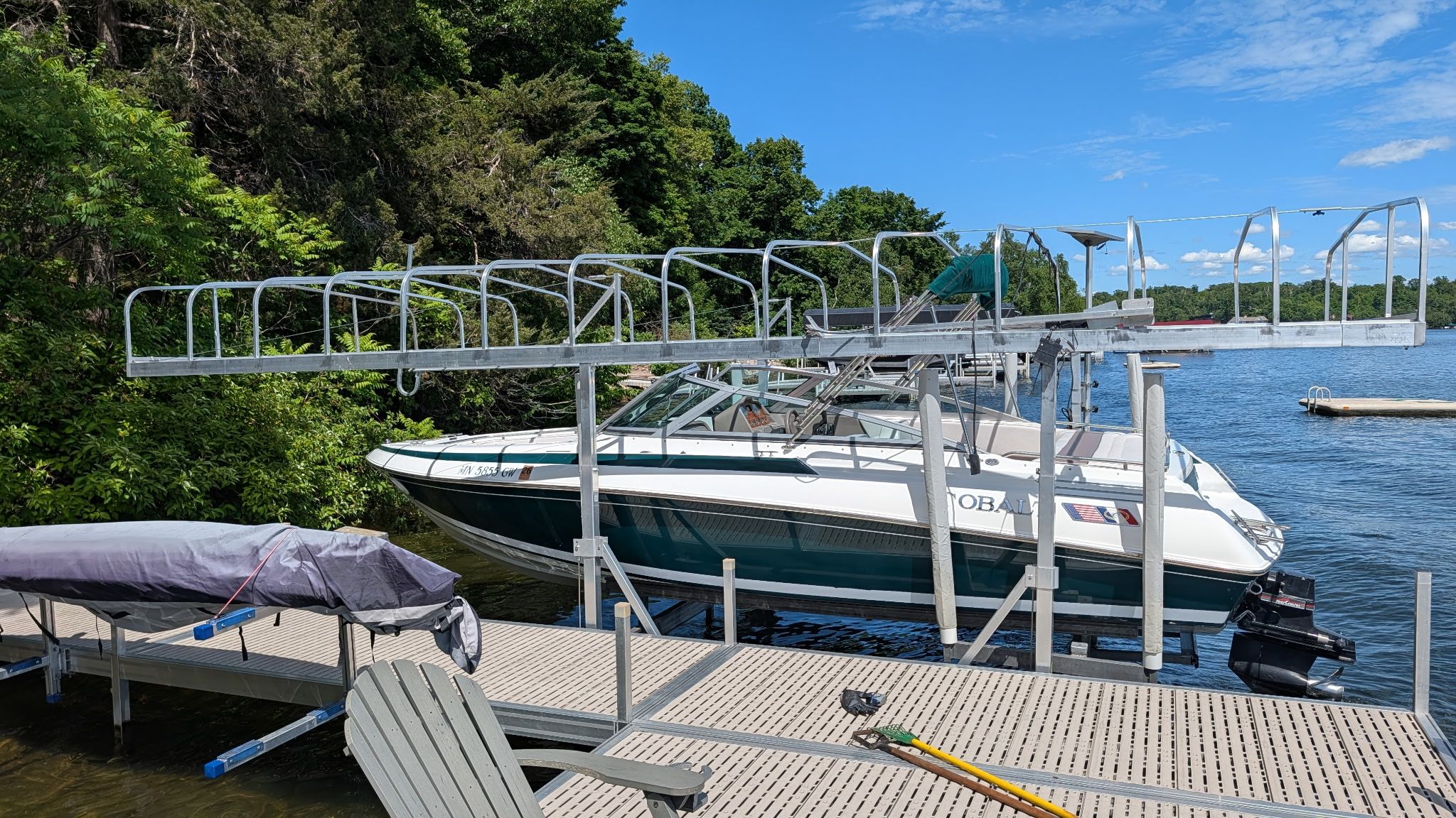 A 1995 Cobalt 222 boat is docked at a serene lakeside setting.