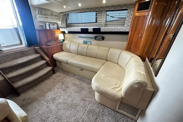 Interior of 2004 Carver 360 Mariner with beige leather seating and cozy decor.