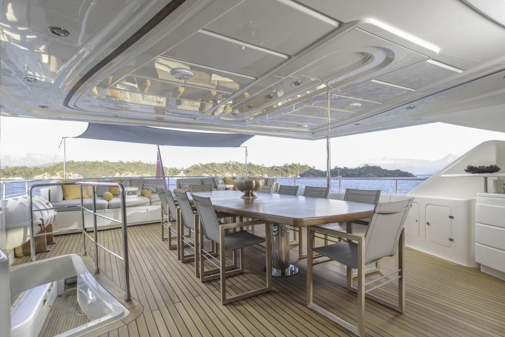 Luxurious CRN 129 yacht deck with dining area, ocean view, and modern furnishings, 2009 model.