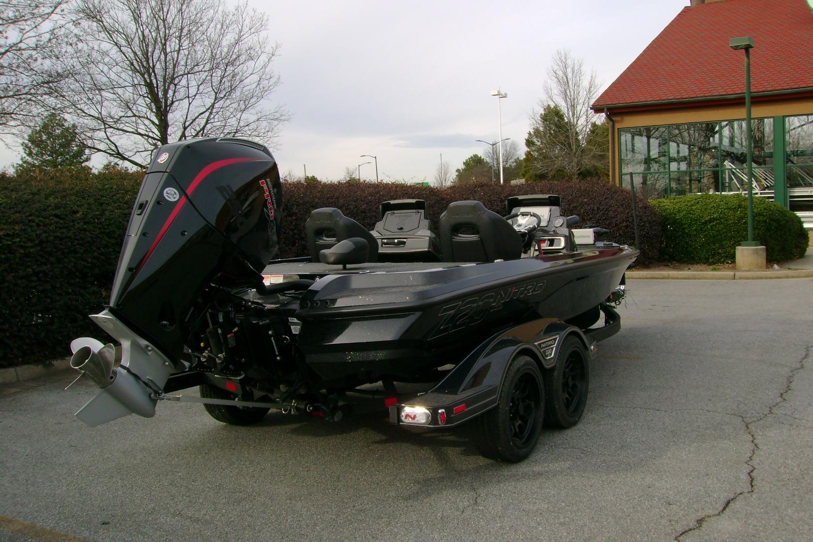 2026 Nitro Z20 XL Pro boat with powerful outboard motor in a parking lot.
