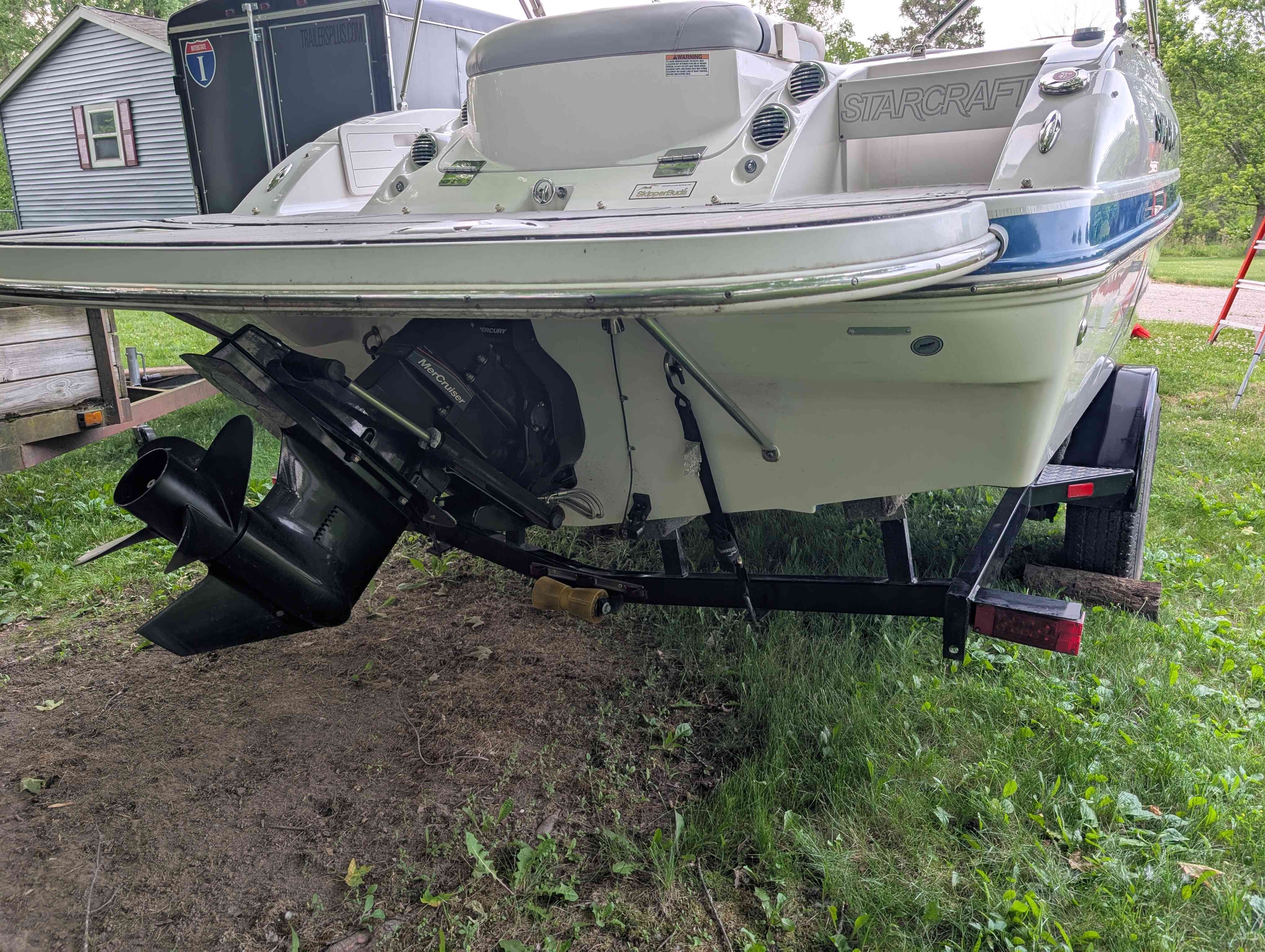 2015 Starcraft 2000 boat on a trailer outdoors.