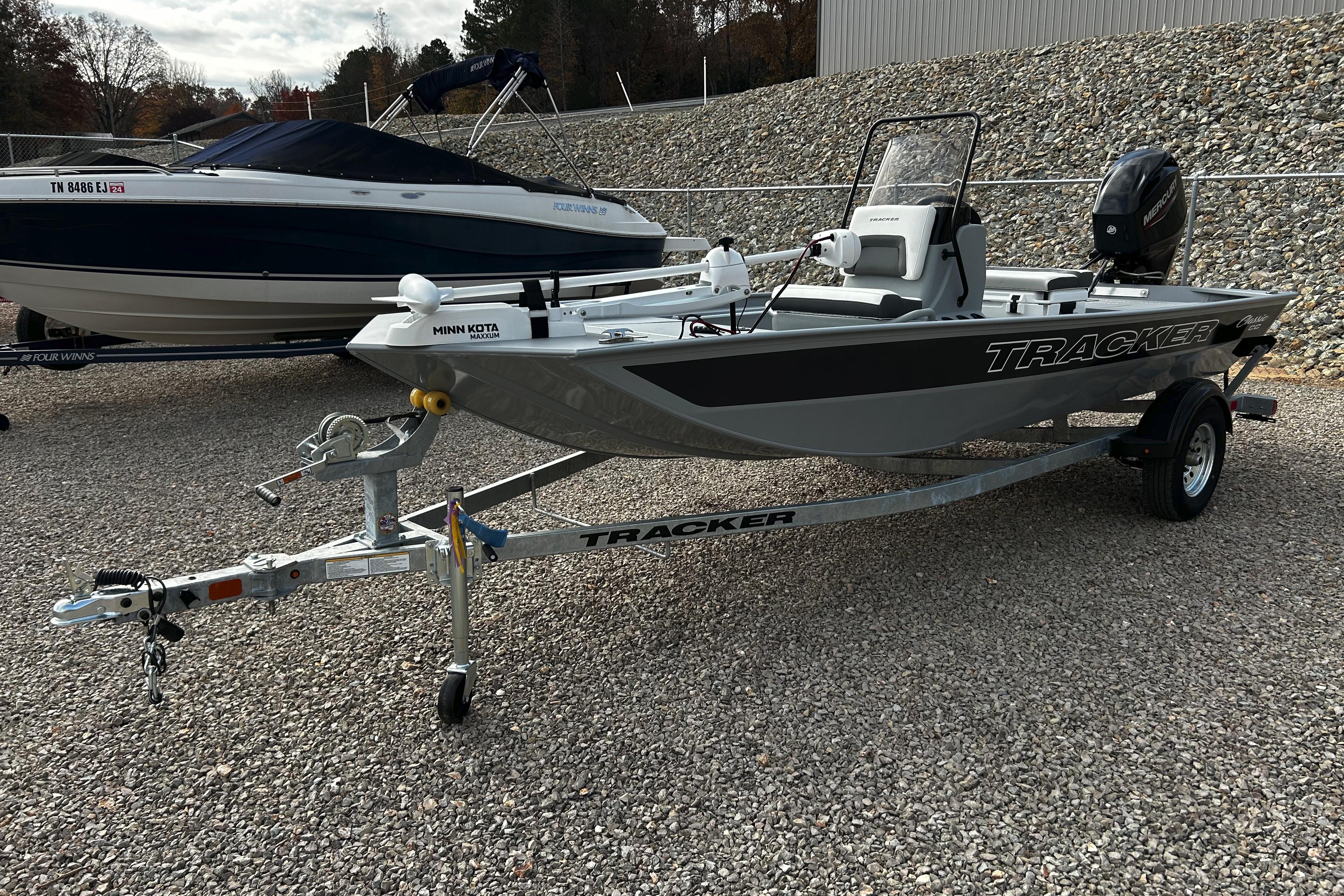 2026 Tracker Bass Tracker Classic CC boat on trailer, parked outdoors.