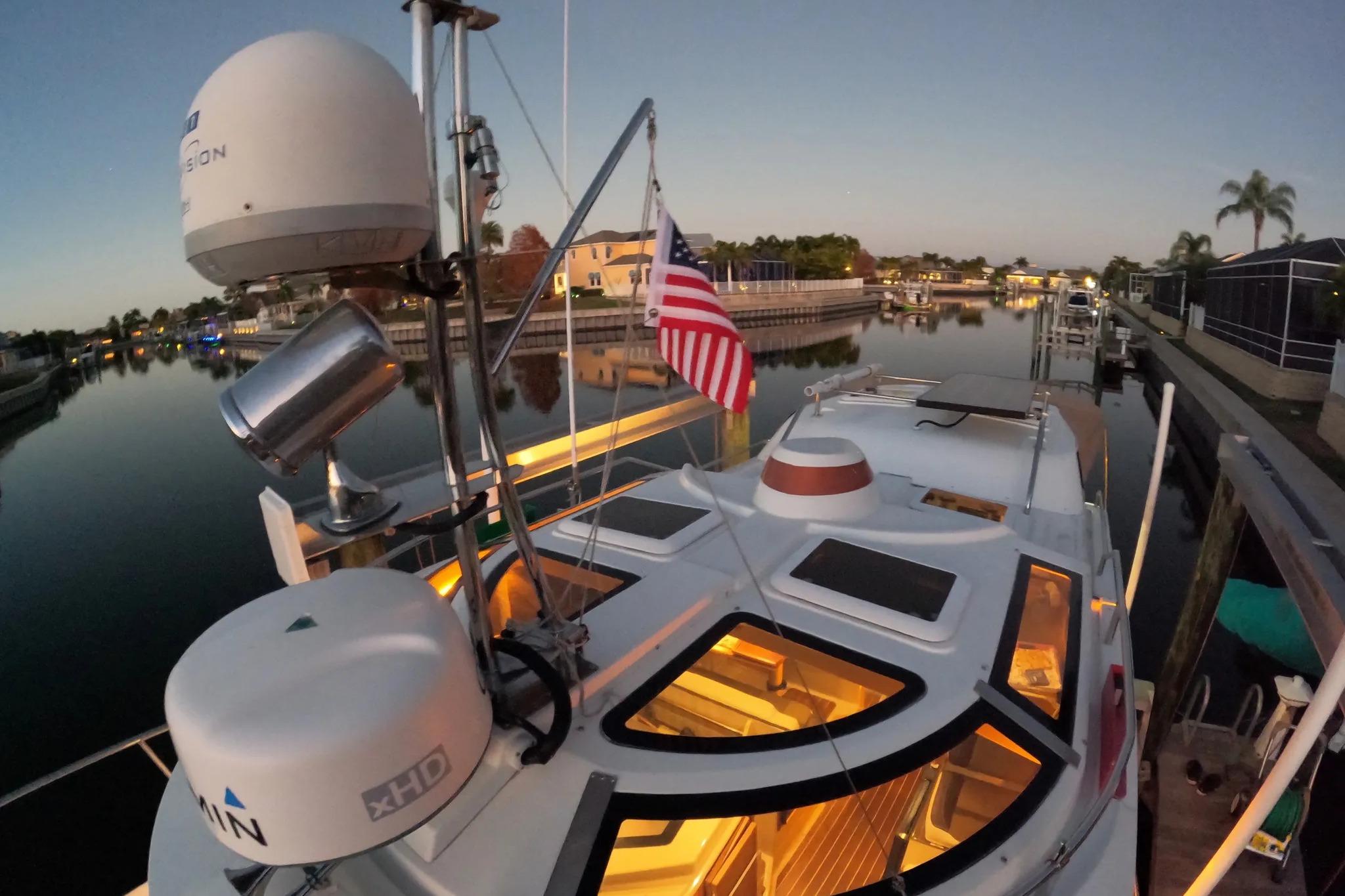 2015 Ranger Tugs R-29 S docked at sunset with American flag and radar equipment.
