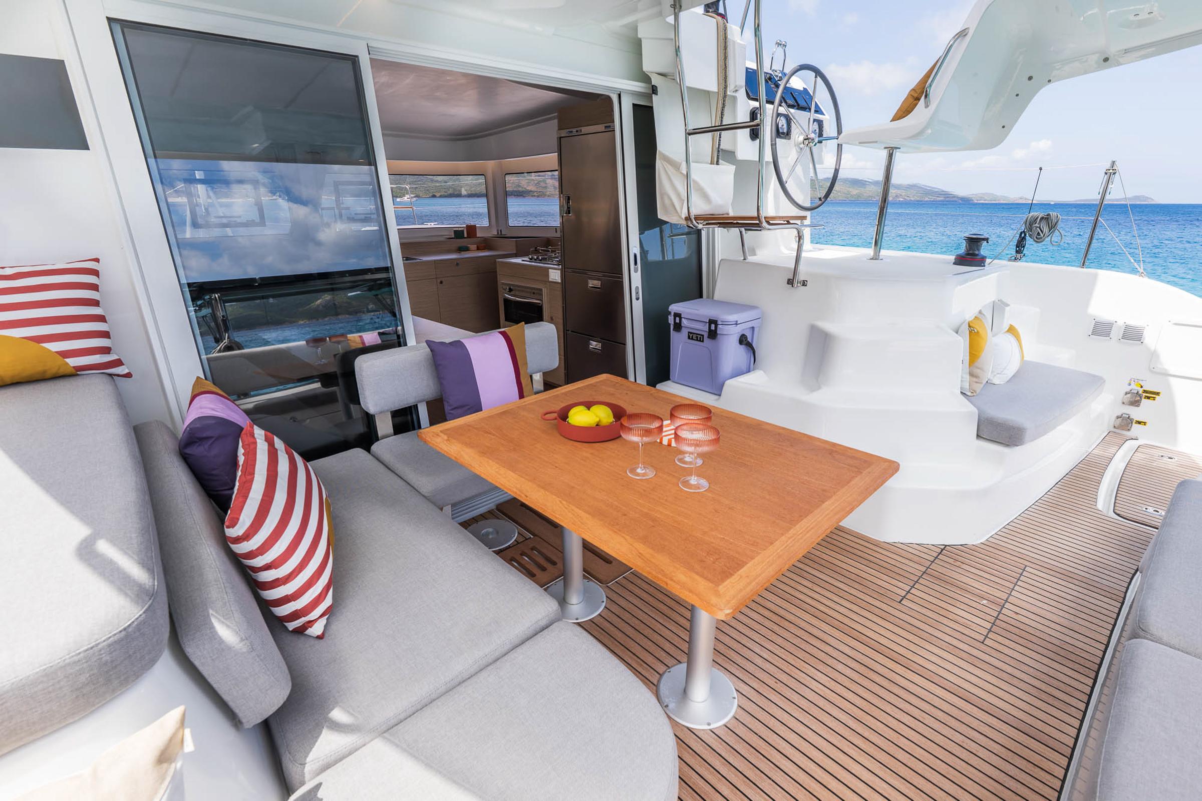 Luxurious Lagoon 38 catamaran interior, featuring a stylish seating area and ocean view, 2025 model.
