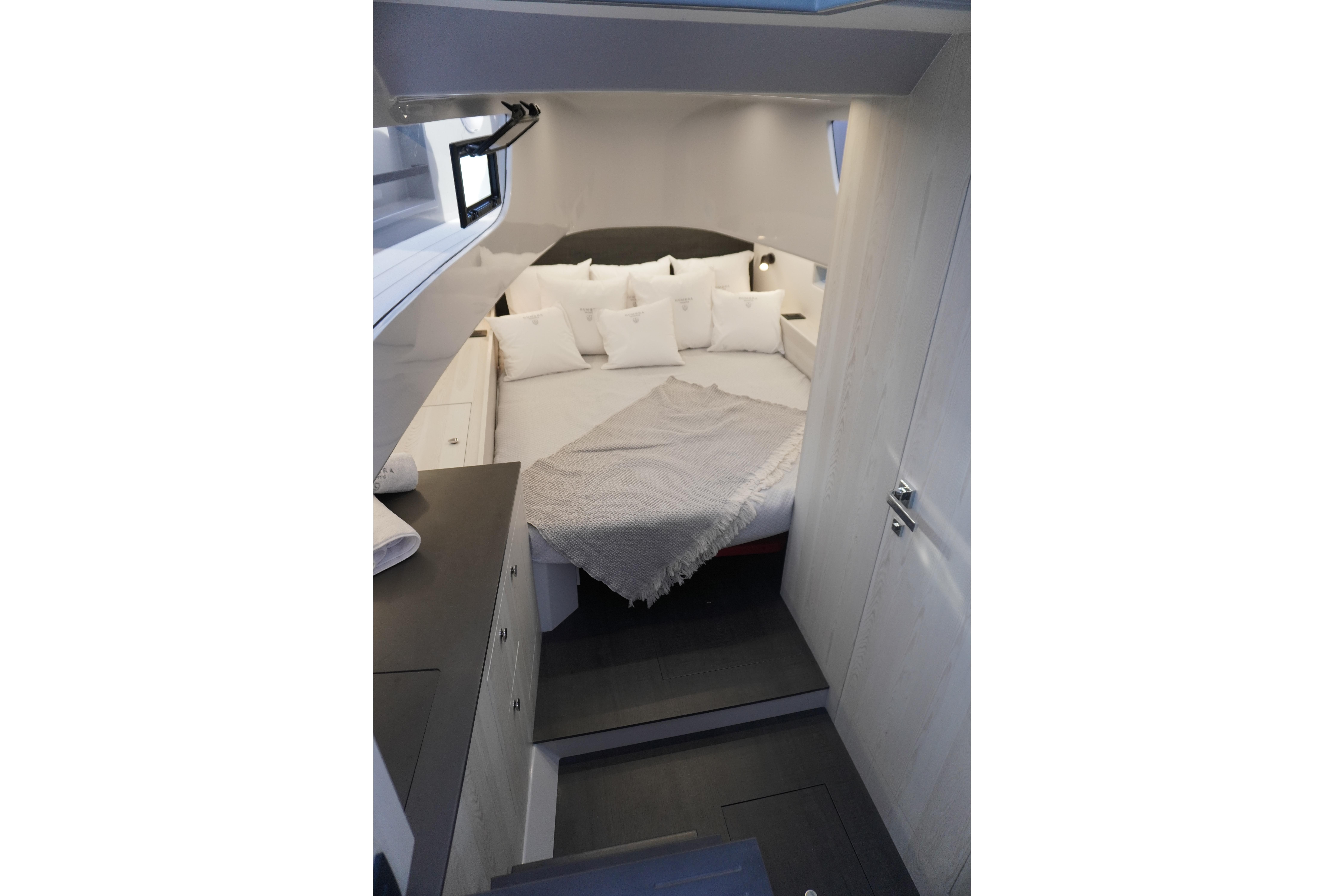 Modern Kumbra 36 yacht interior, featuring a cozy bed with white pillows, 2026 model.