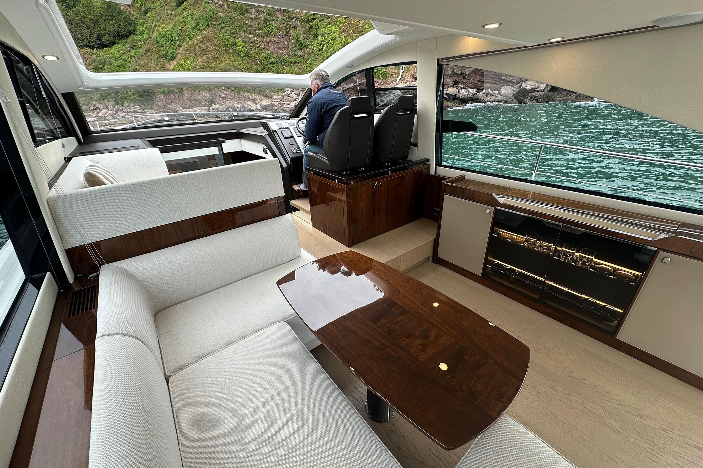 Luxurious interior of 2022 Fairline Targa 50 GT yacht with elegant seating and scenic views.