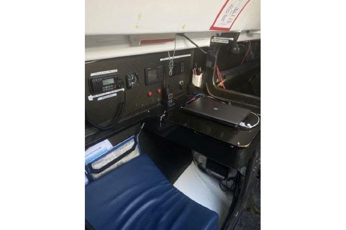 Control panel inside Andrews 63, 2000 model, featuring communication equipment and a laptop.