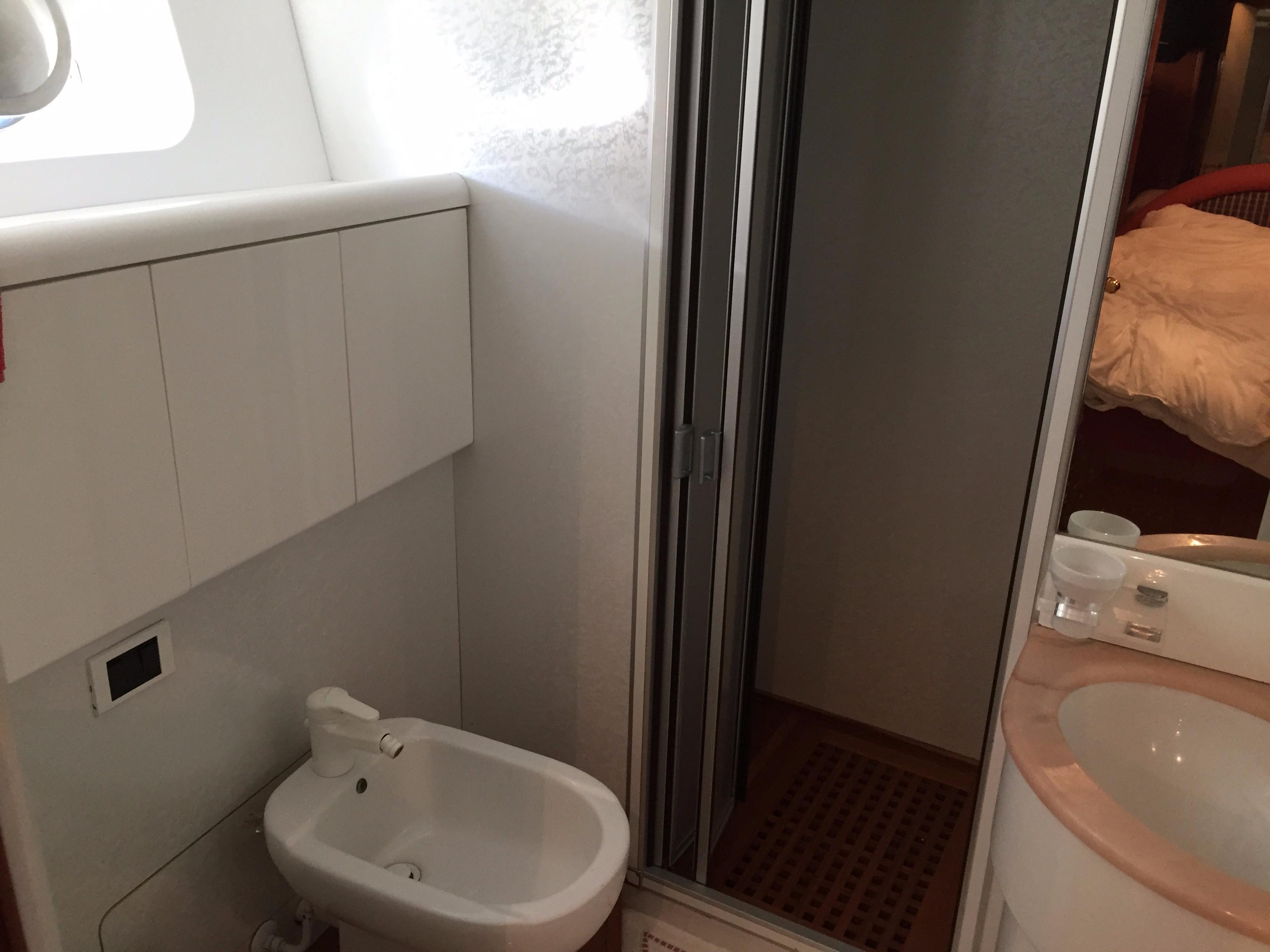 Bathroom interior of a 1994 Falcon 76 yacht, featuring a bidet and sink.
