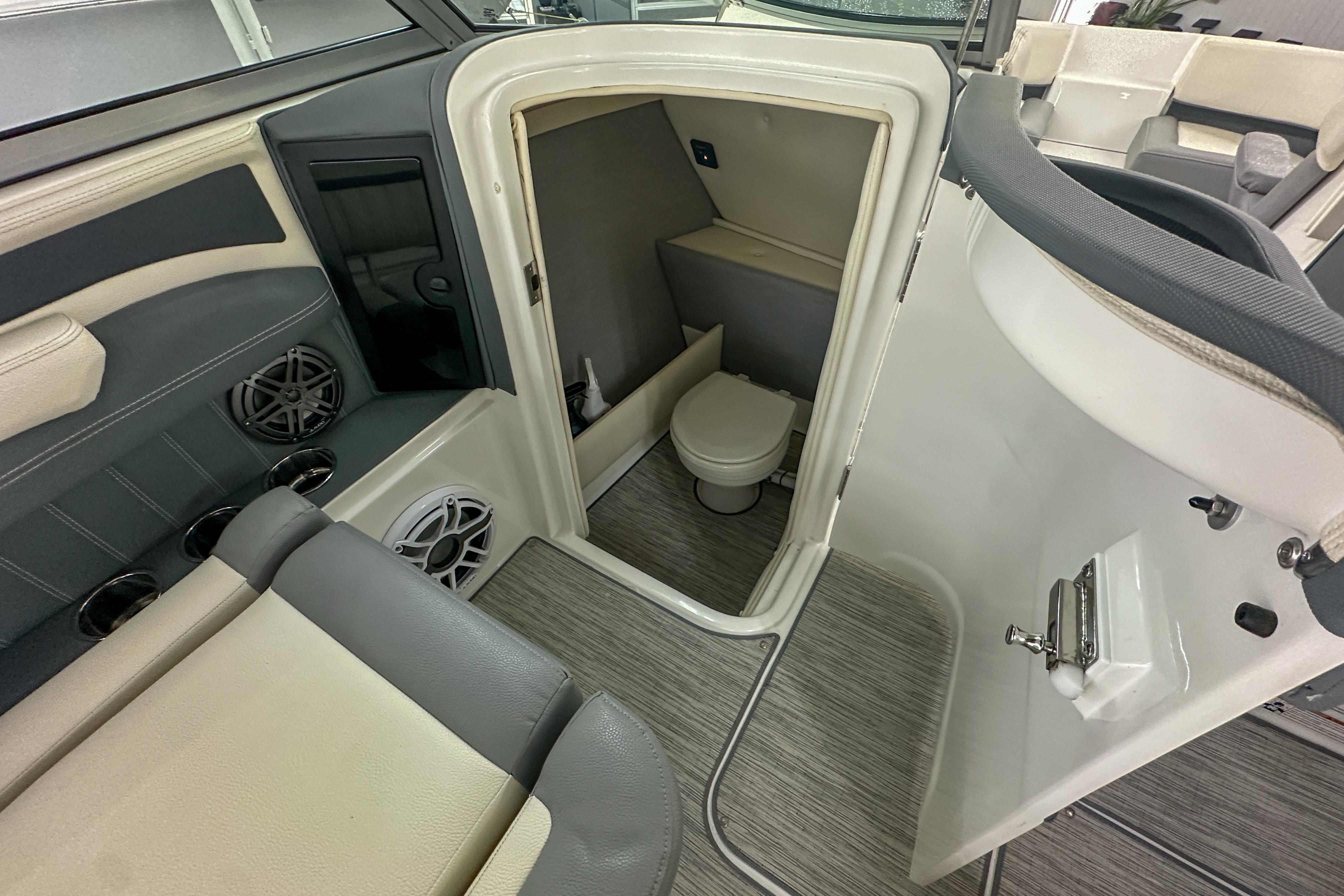 2022 Cobalt 25SC boat interior with compact bathroom and seating area.