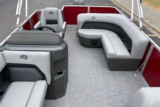 2026 Sun Tracker Party Barge 18 DLX interior with gray seating and red accents.
