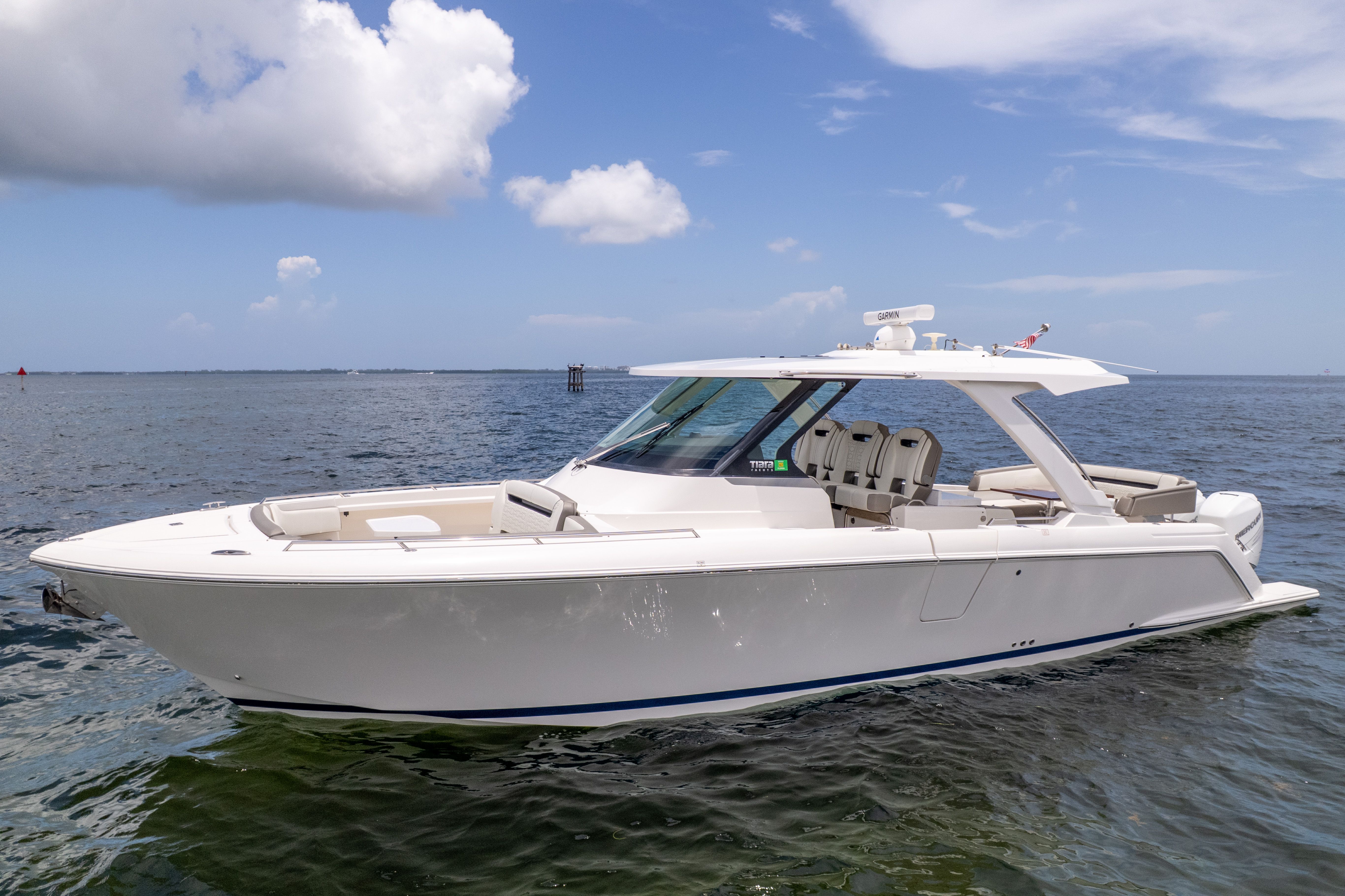 The 2023 Tiara Yachts 38 LS is a sleek motorboat on calm water.