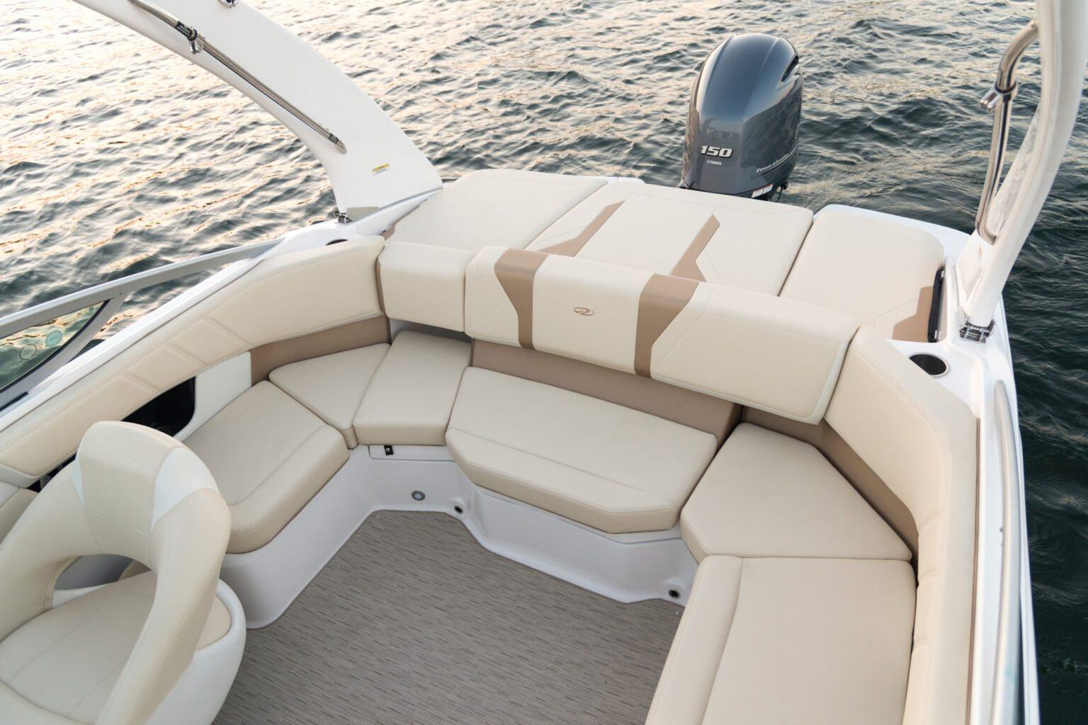 2026 Regal 21 OBX boat interior with beige seating, on calm water.