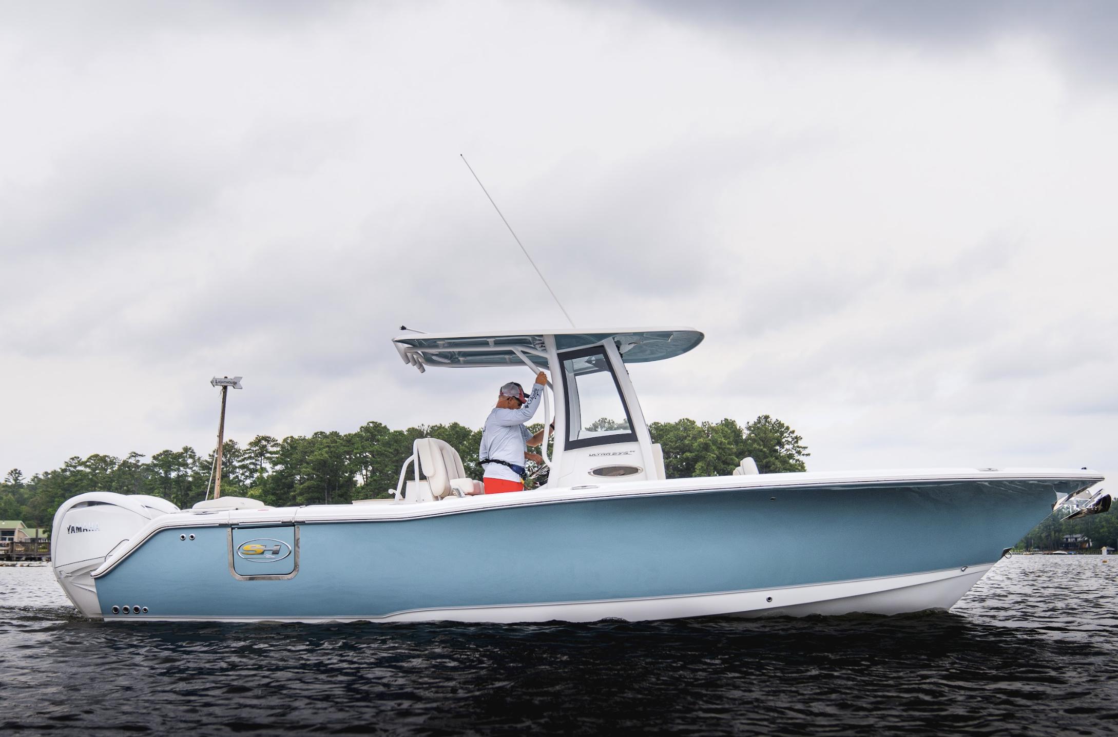 2025 Sea Hunt Ultra 275 SE boat on calm water, overcast sky.